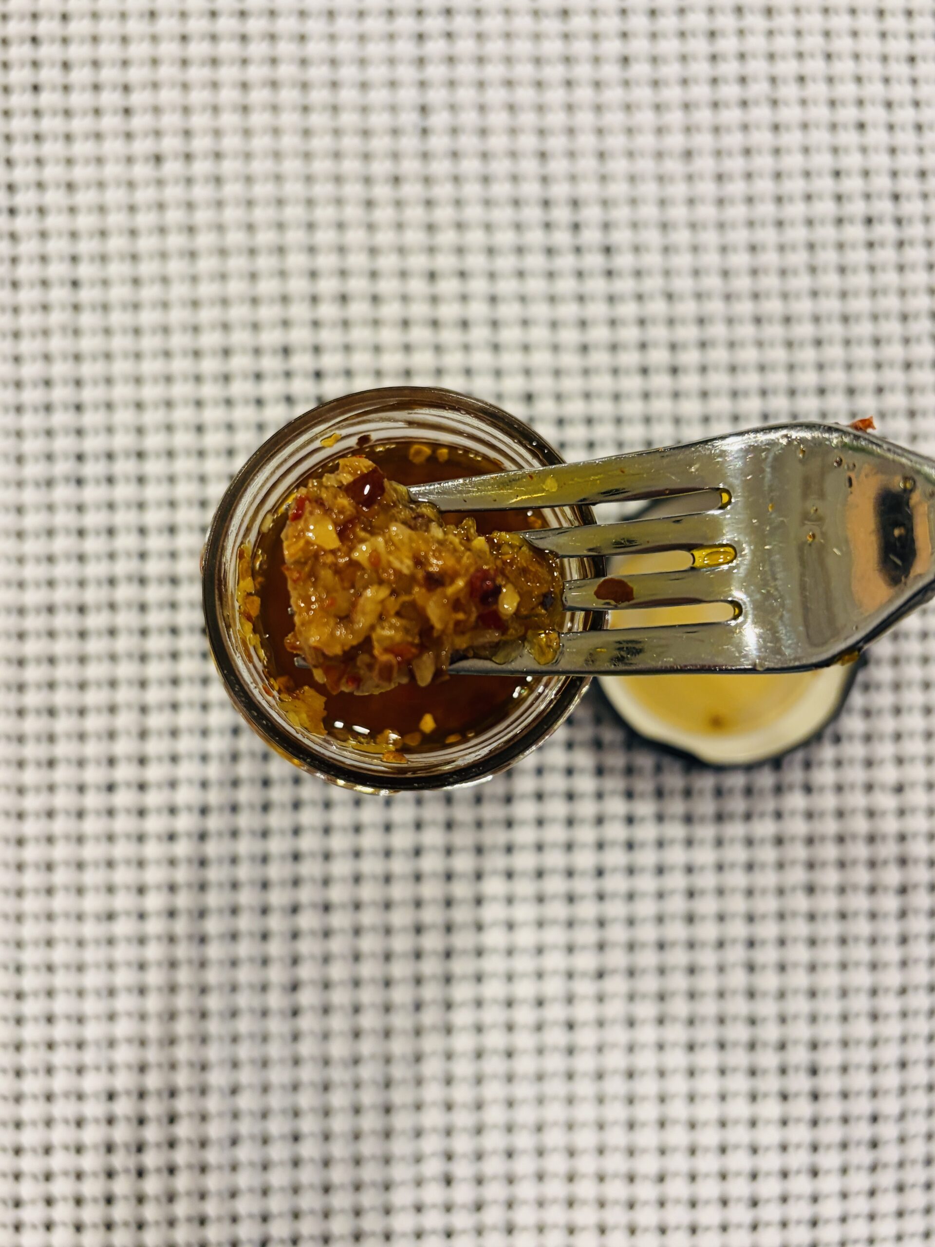 Alessi Calabrian chili crisp fork pull showing crispy garlic and onion bits — Flavor Index Lab
