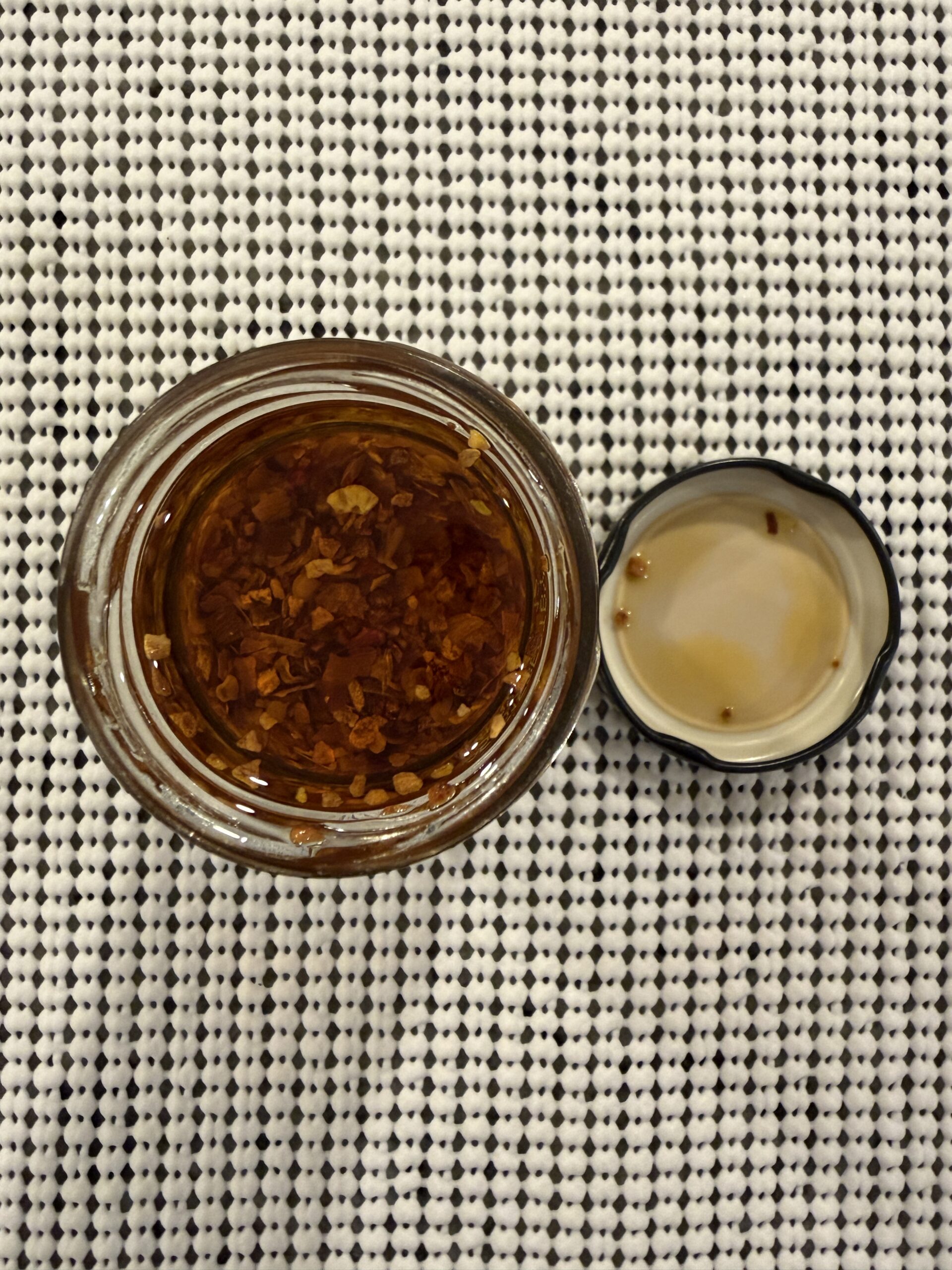 Alessi Calabrian chili crisp settlement showing olive oil and chili bits — Flavor Index Lab