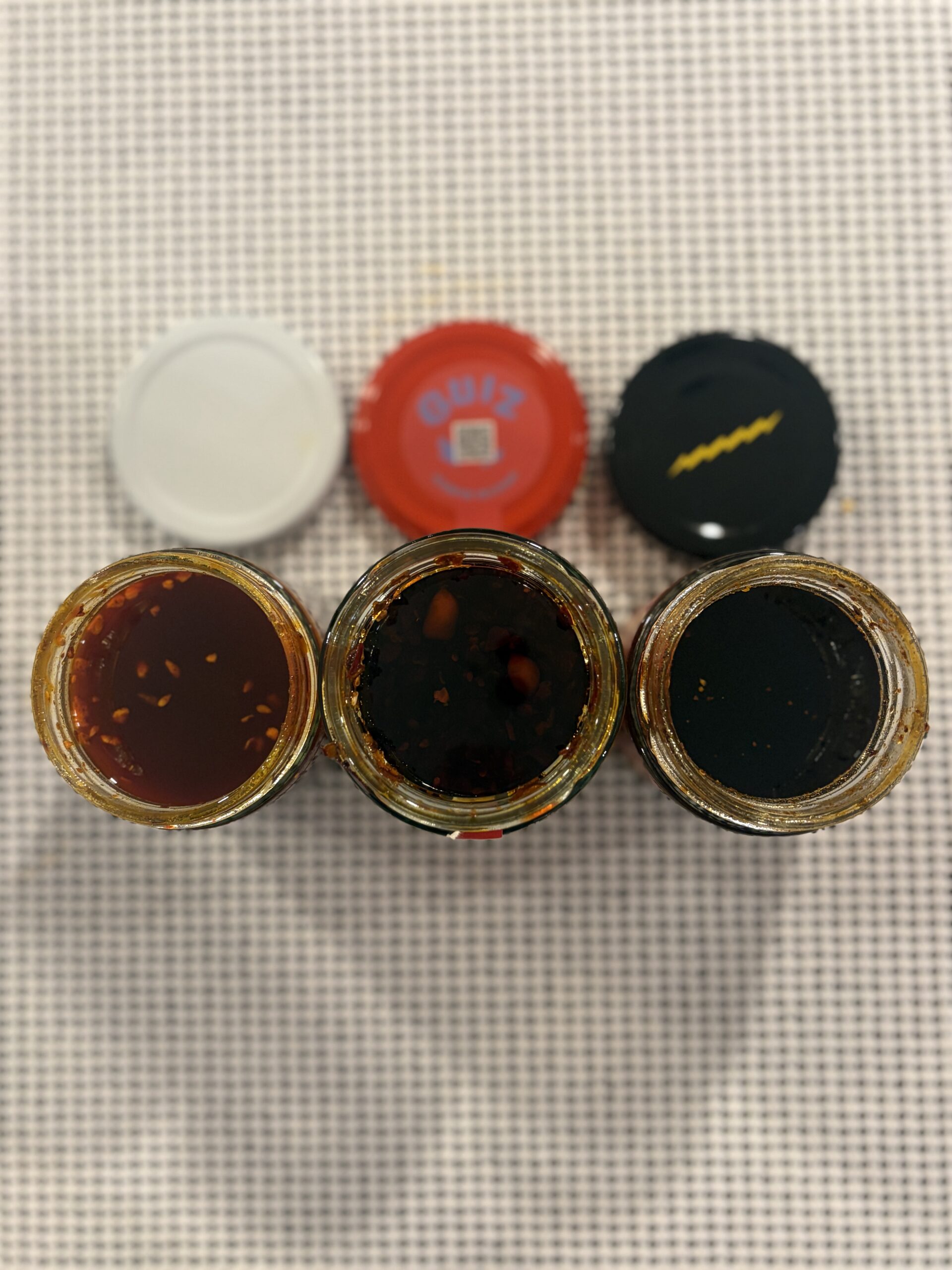 GUIZ, Fly By Jing, and Momofuku chili crisp jars together — Flavor Index Lab