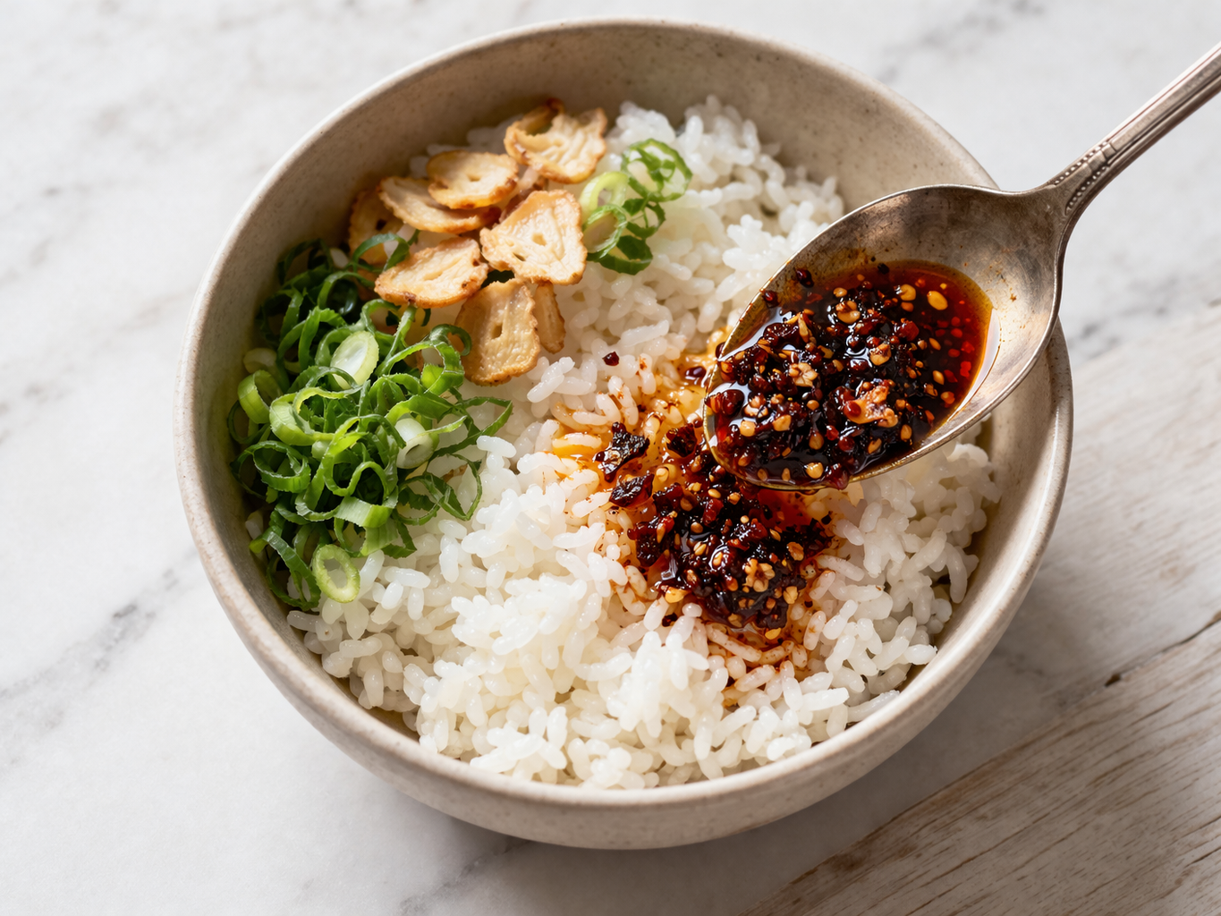Chili crisp spooned over a rice bowl — a universal serving method — Flavor Index Lab