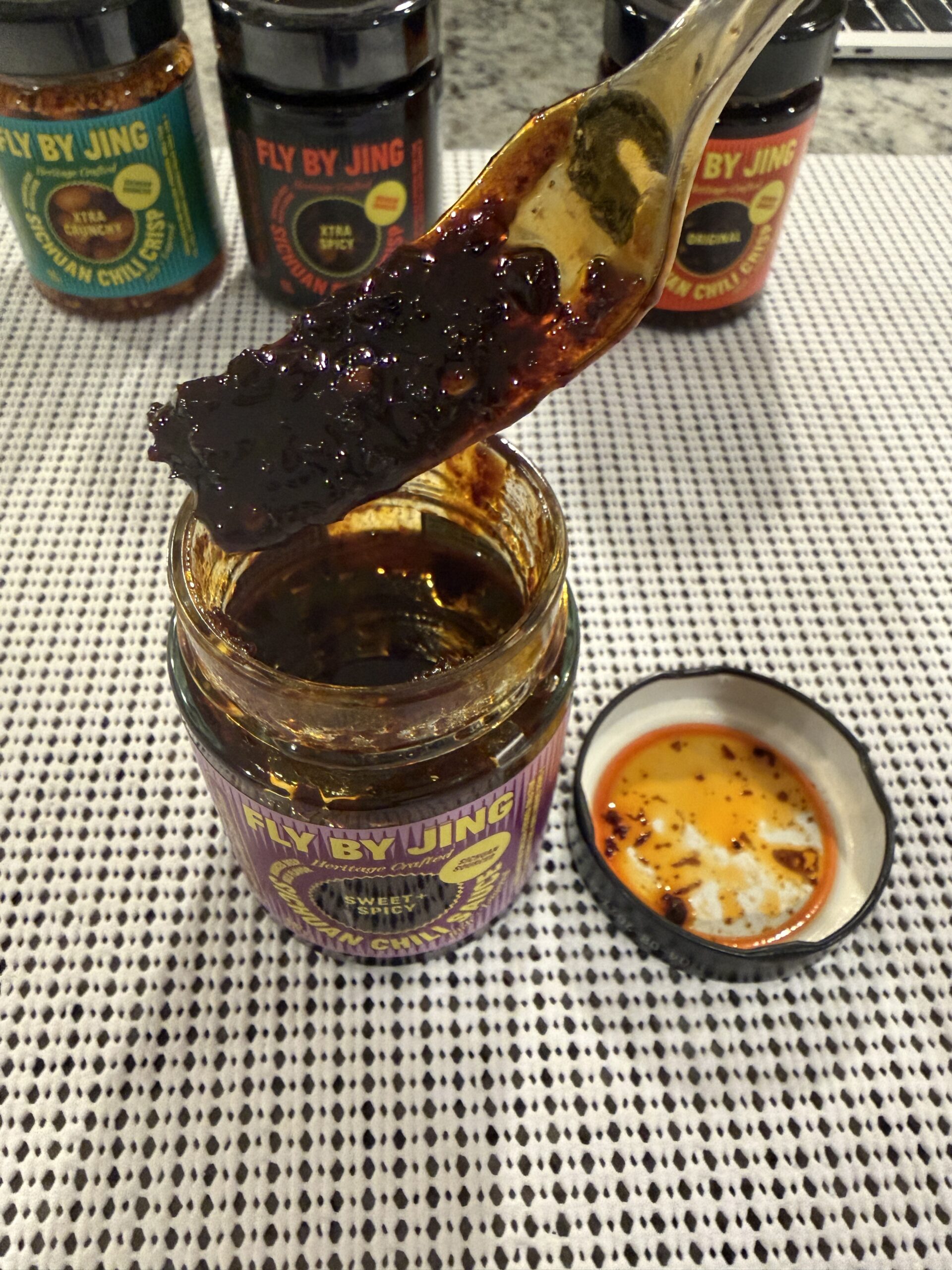 Fly By Jing Sweet and Spicy chili sauce on a fork showing thick texture — Flavor Index Lab