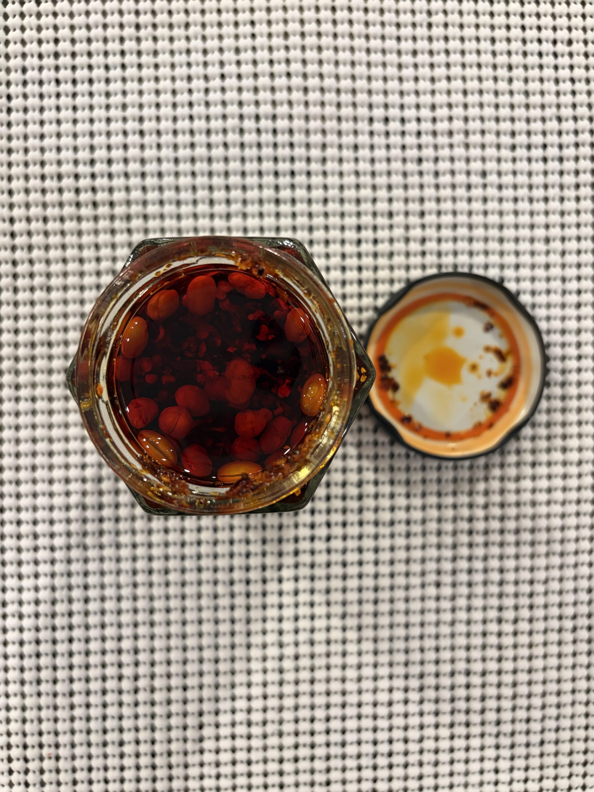 Fusion Select chili crisp open jar with clear dark red oil and floating soybeans — Flavor Index Lab