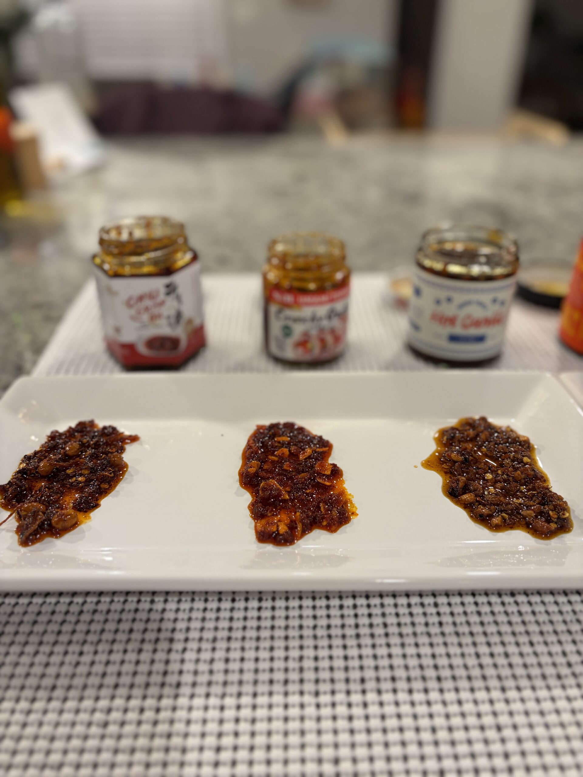 S&B, Fusion Select, and Momofuku garlic chili crisps plated for comparison — Flavor Index Lab