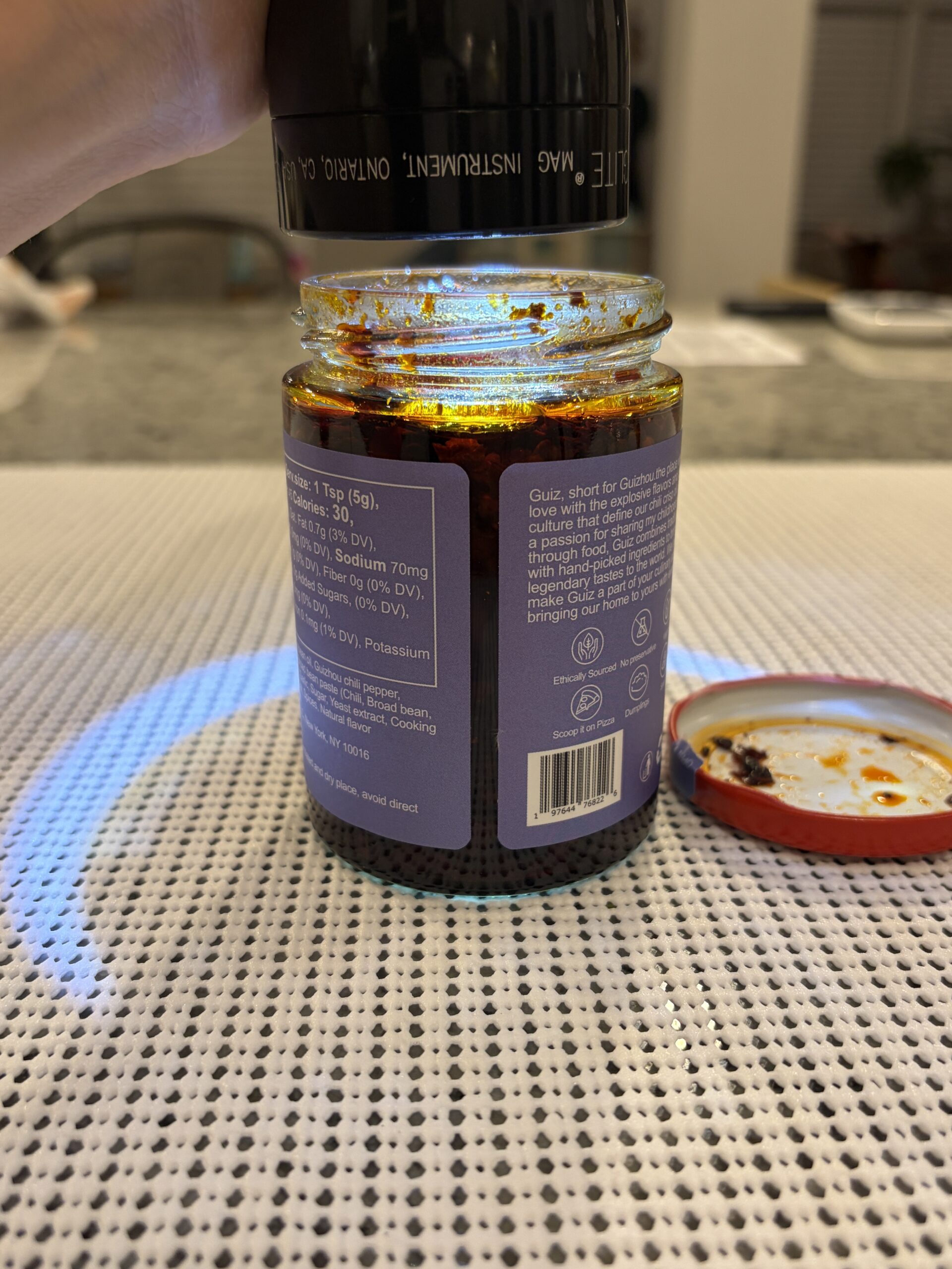 GUIZ black bean chili crisp settlement showing solids packed to the top — Flavor Index Lab