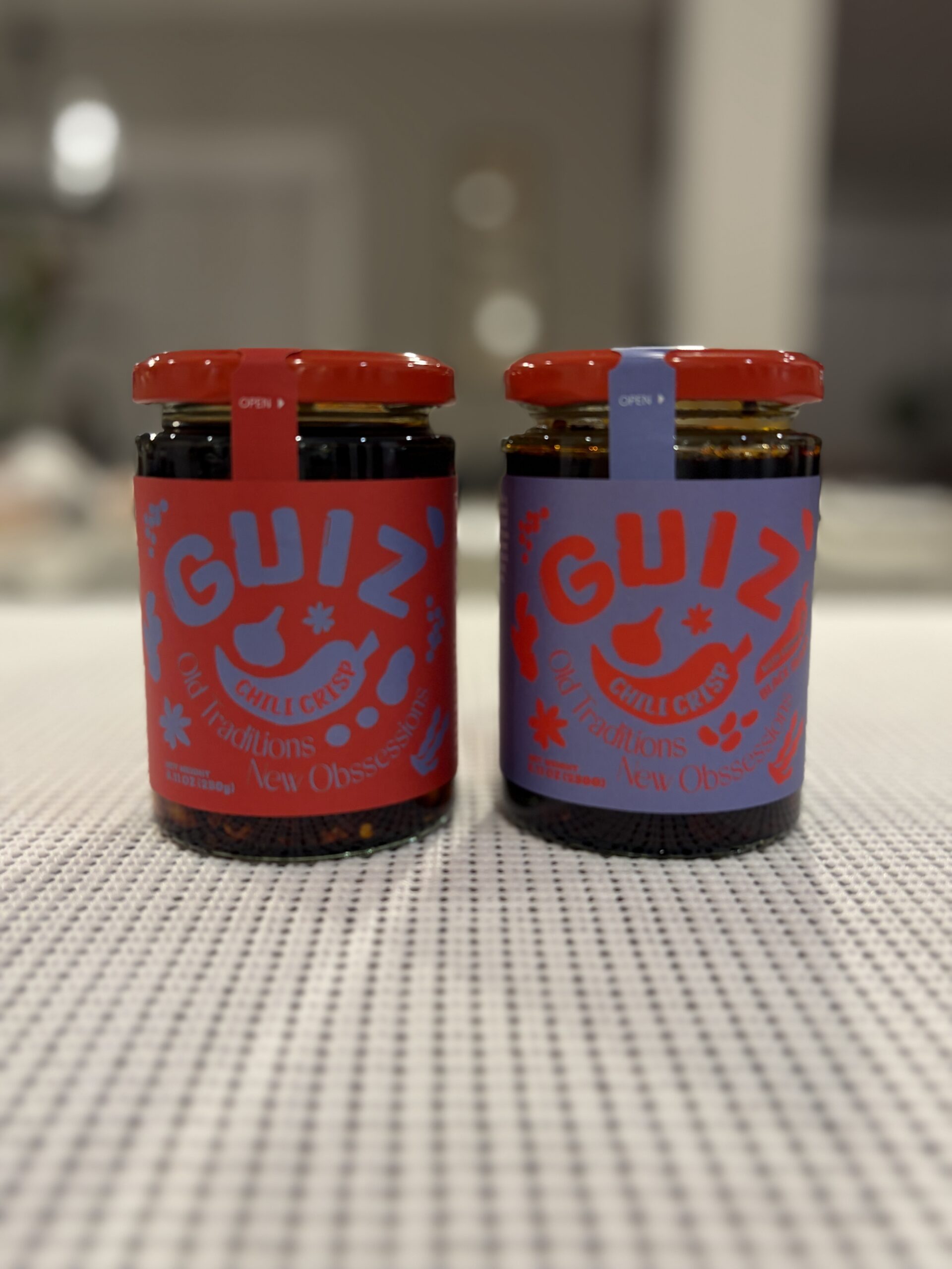 GUIZ chili crisp comparison close-up of both jar labels — Flavor Index Lab