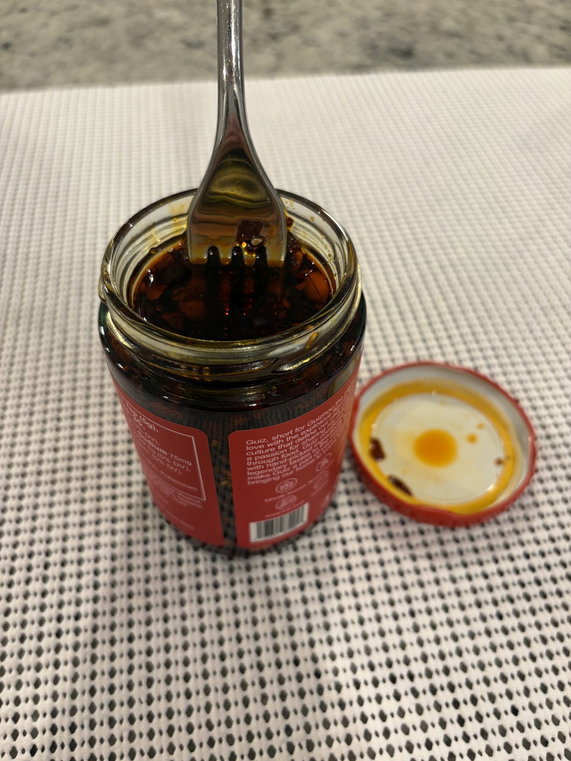 GUIZ Original chili crisp fork pull loaded with peanuts and chili flakes — Flavor Index Lab