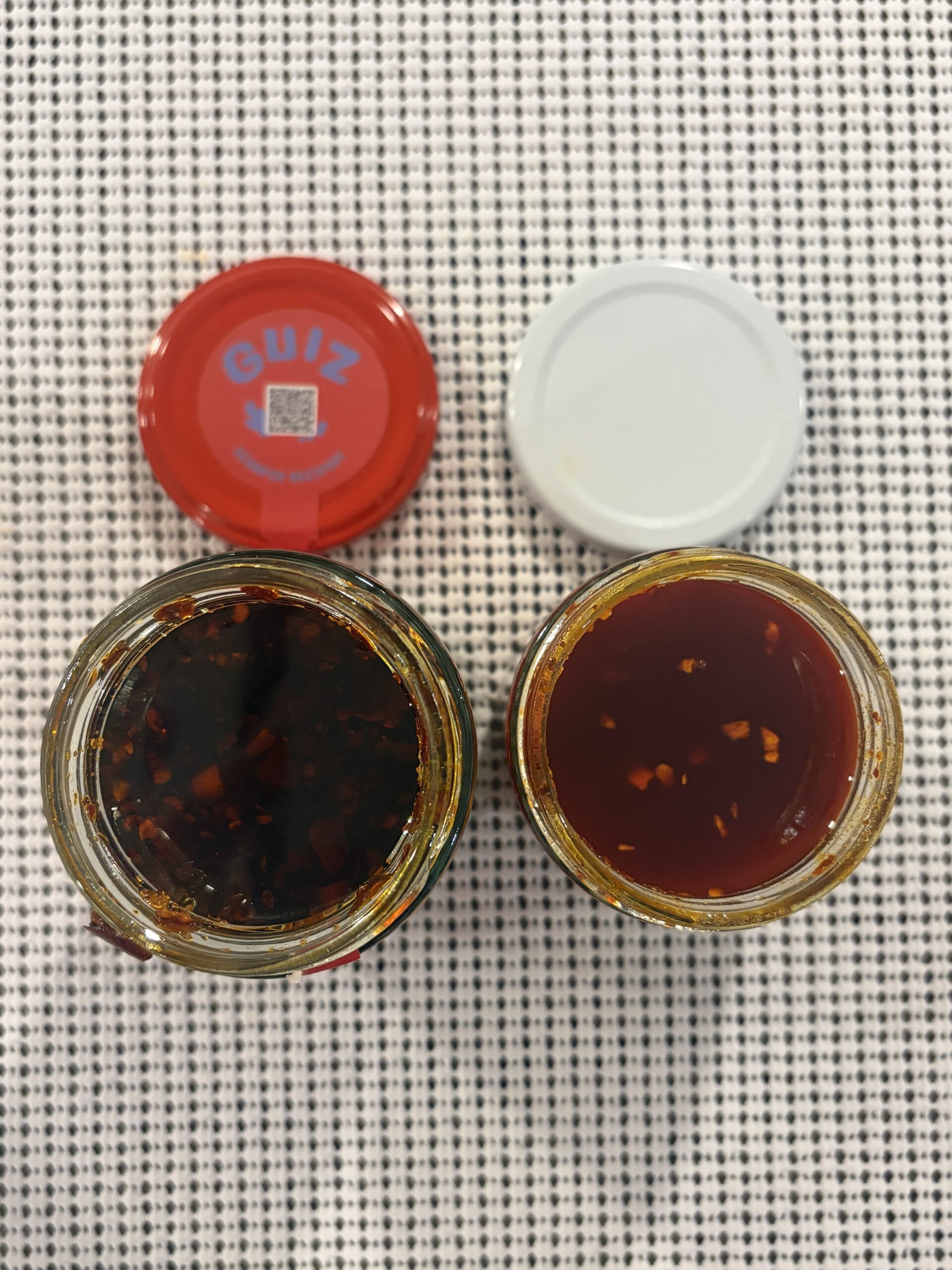 GUIZ and Momofuku chili crisp open jars showing crunch comparison — Flavor Index Lab