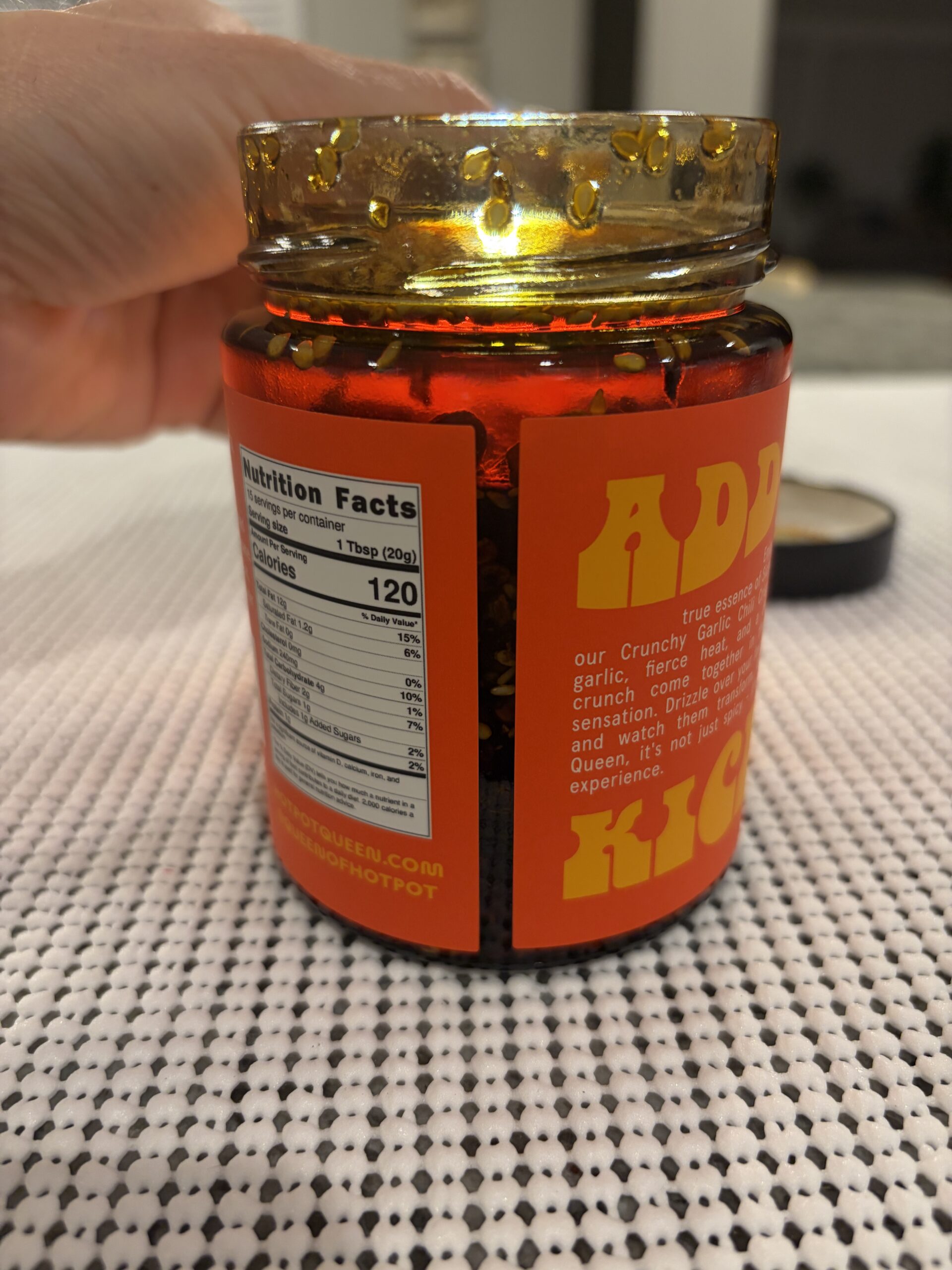 Hotpot Queen chili crisp settlement showing dense solids with floating sesame seeds — Flavor Index Lab