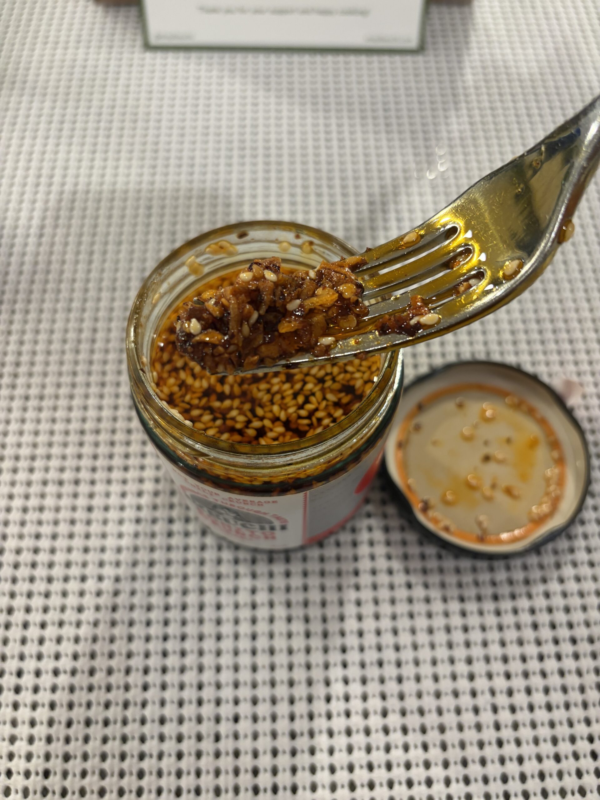 Ikeuchi Bonito Crunch chili crisp fork pull showing oil and bits — Flavor Index Lab