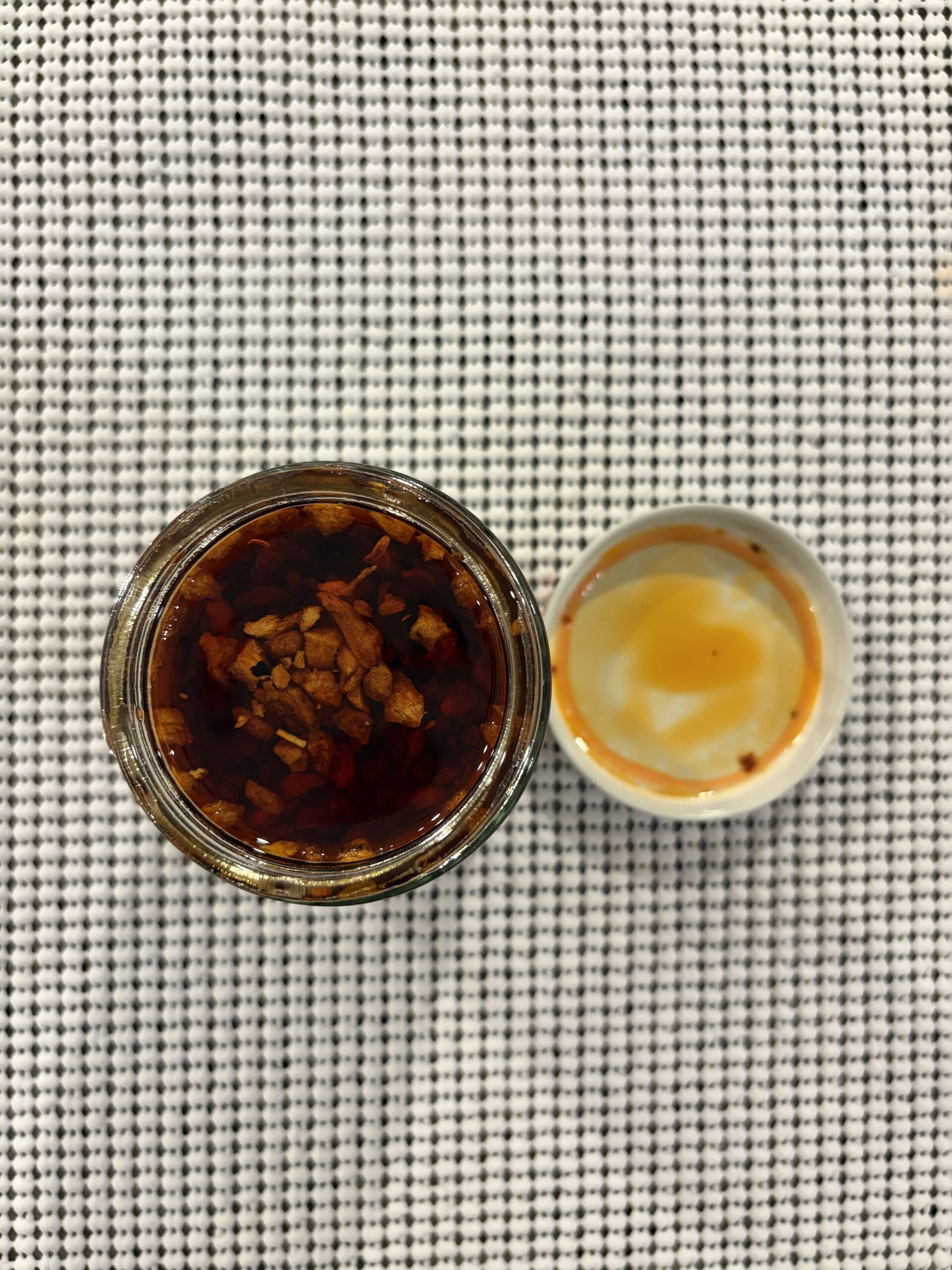 Mama Teav's chili crisp open jar with big fried garlic chunks in dark oil — Flavor Index Lab