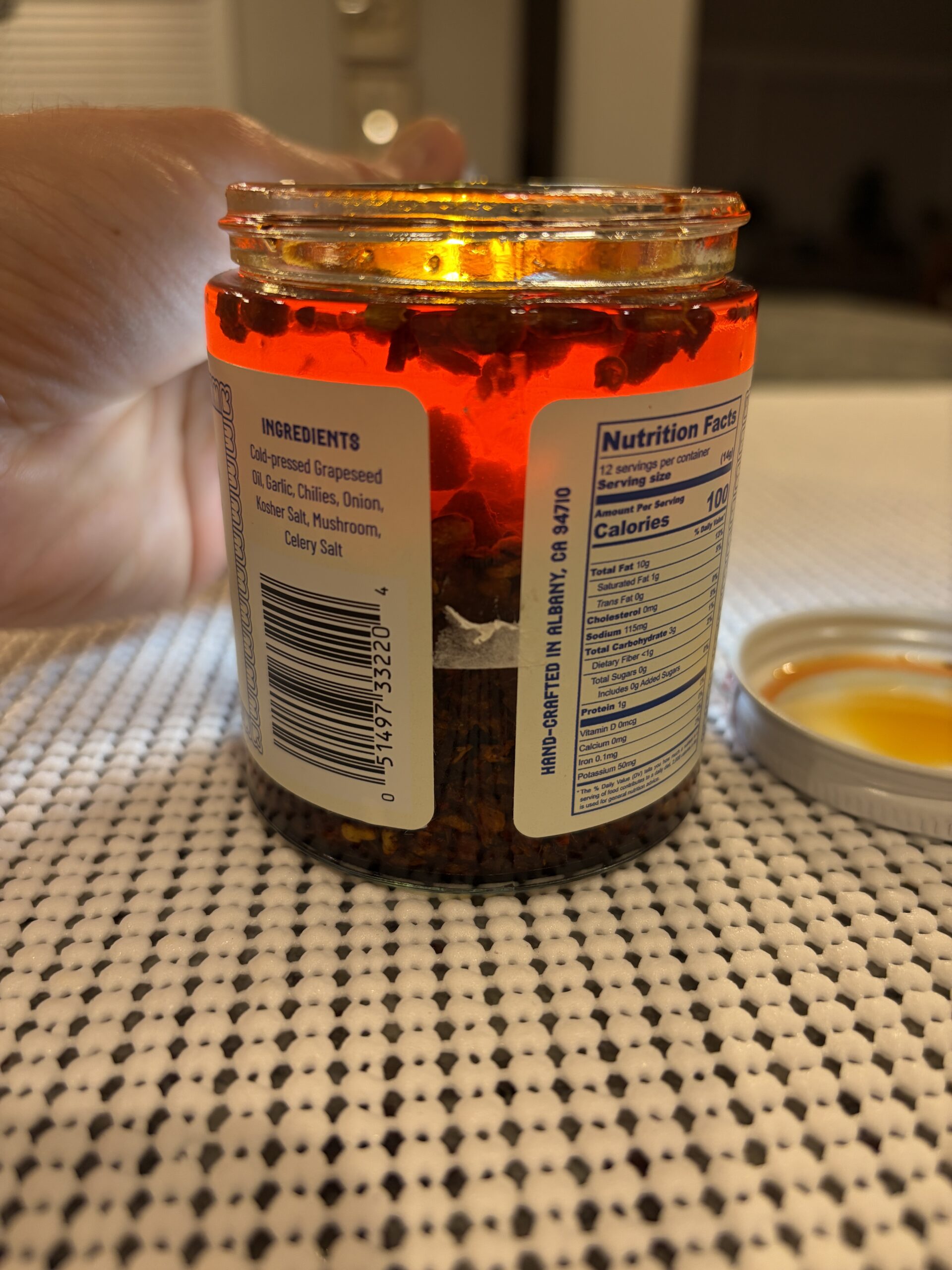Mama Teav's chili crisp settlement showing 60% garlic bits in dark grape seed oil — Flavor Index Lab