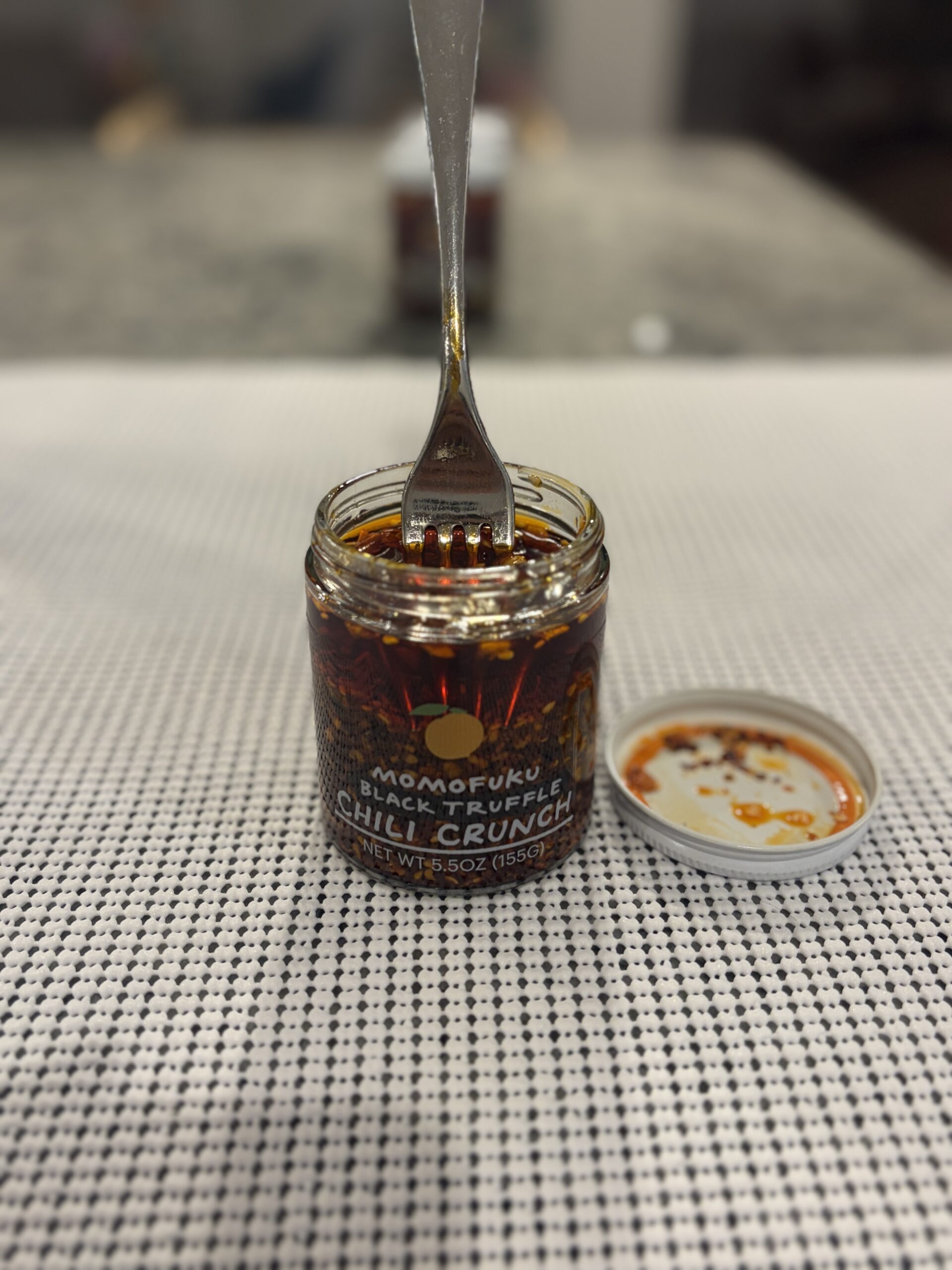 Fork resting on Momofuku Black Truffle Chili Crunch solids without sinking — Flavor Index Lab