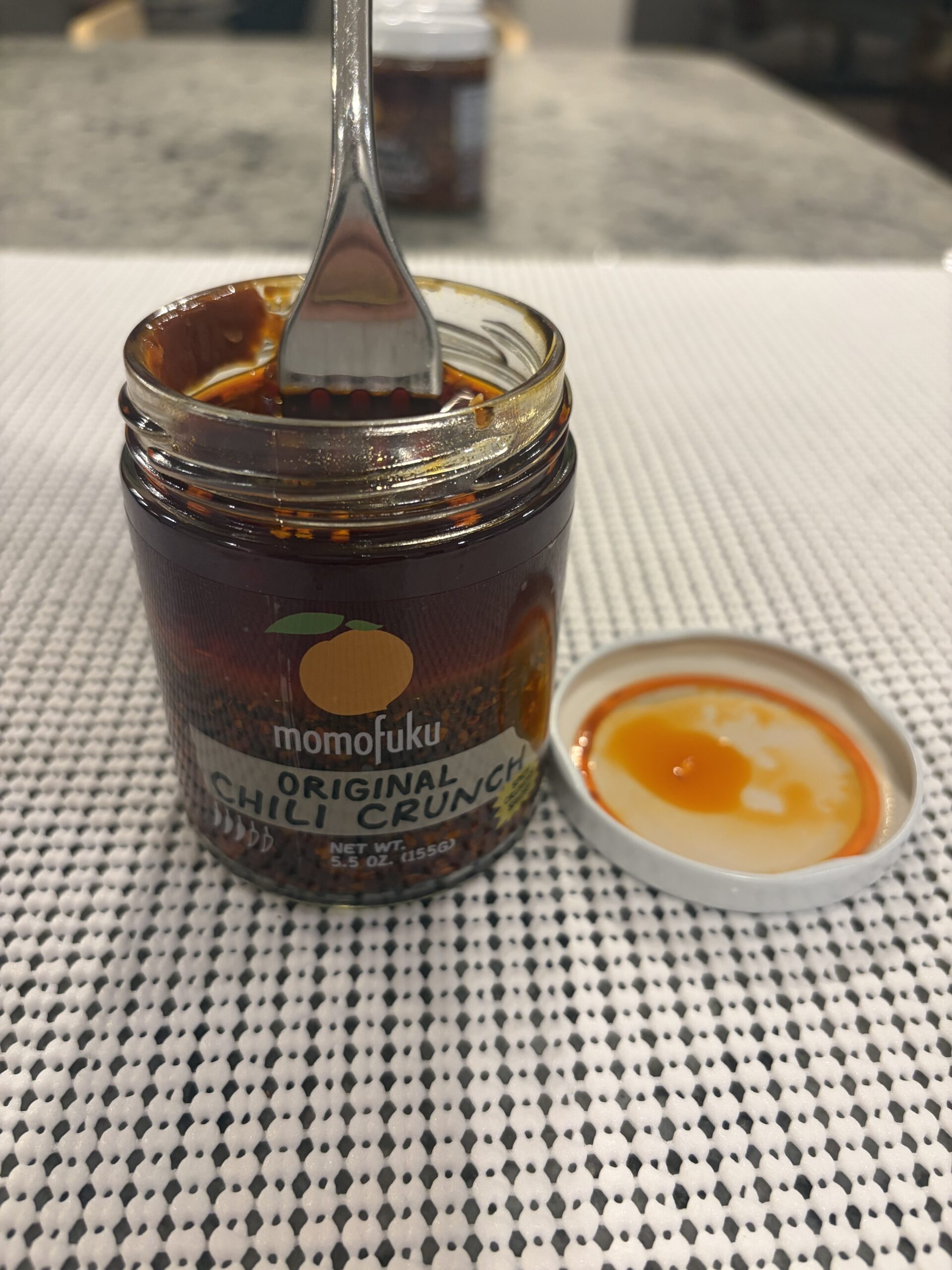 Fork resting on Momofuku Chili Crunch solids without sinking — Flavor Index Lab