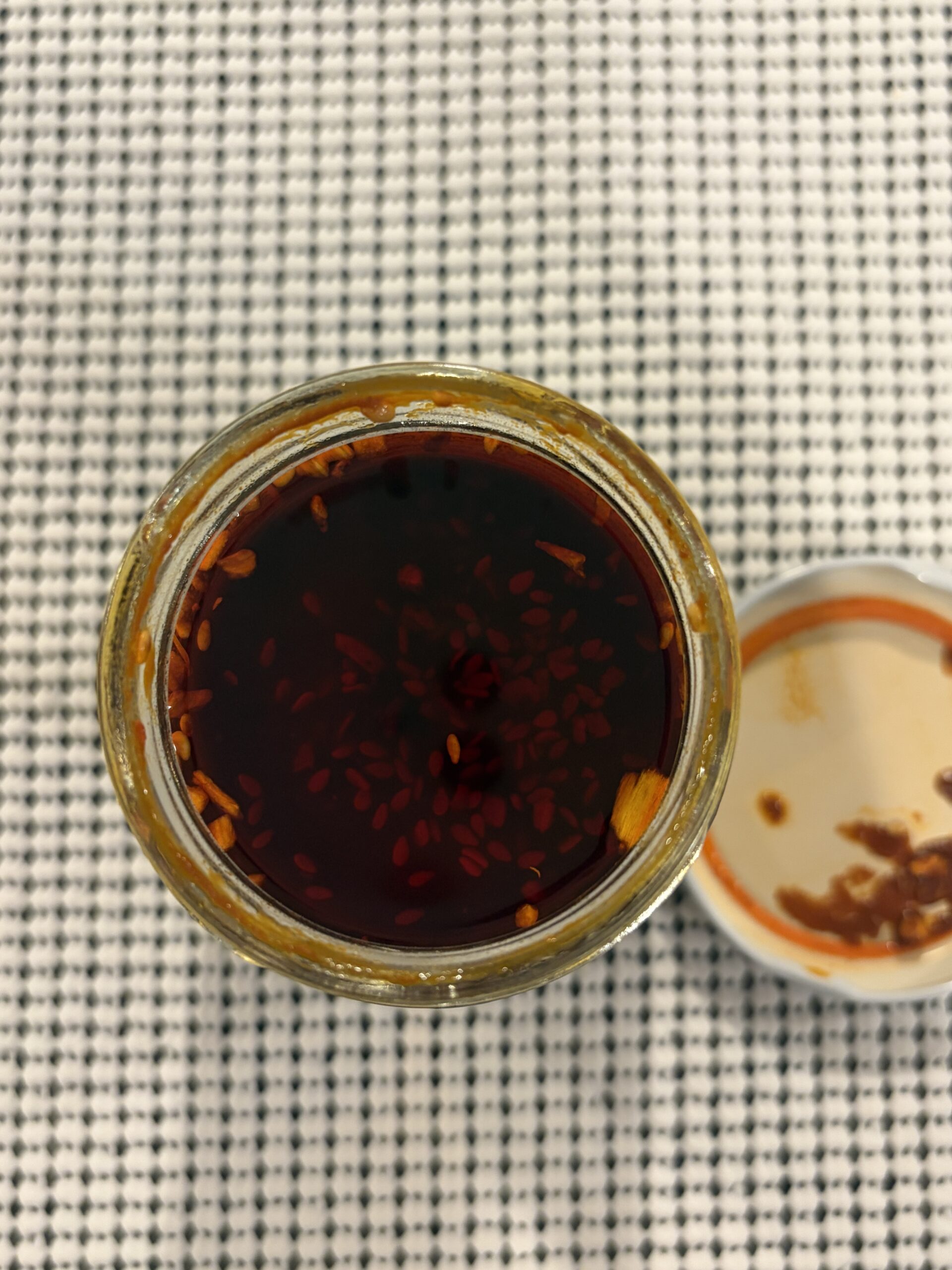 Momofuku Extra Spicy Chili Crunch open jar showing chili bits and oil — Flavor Index Lab