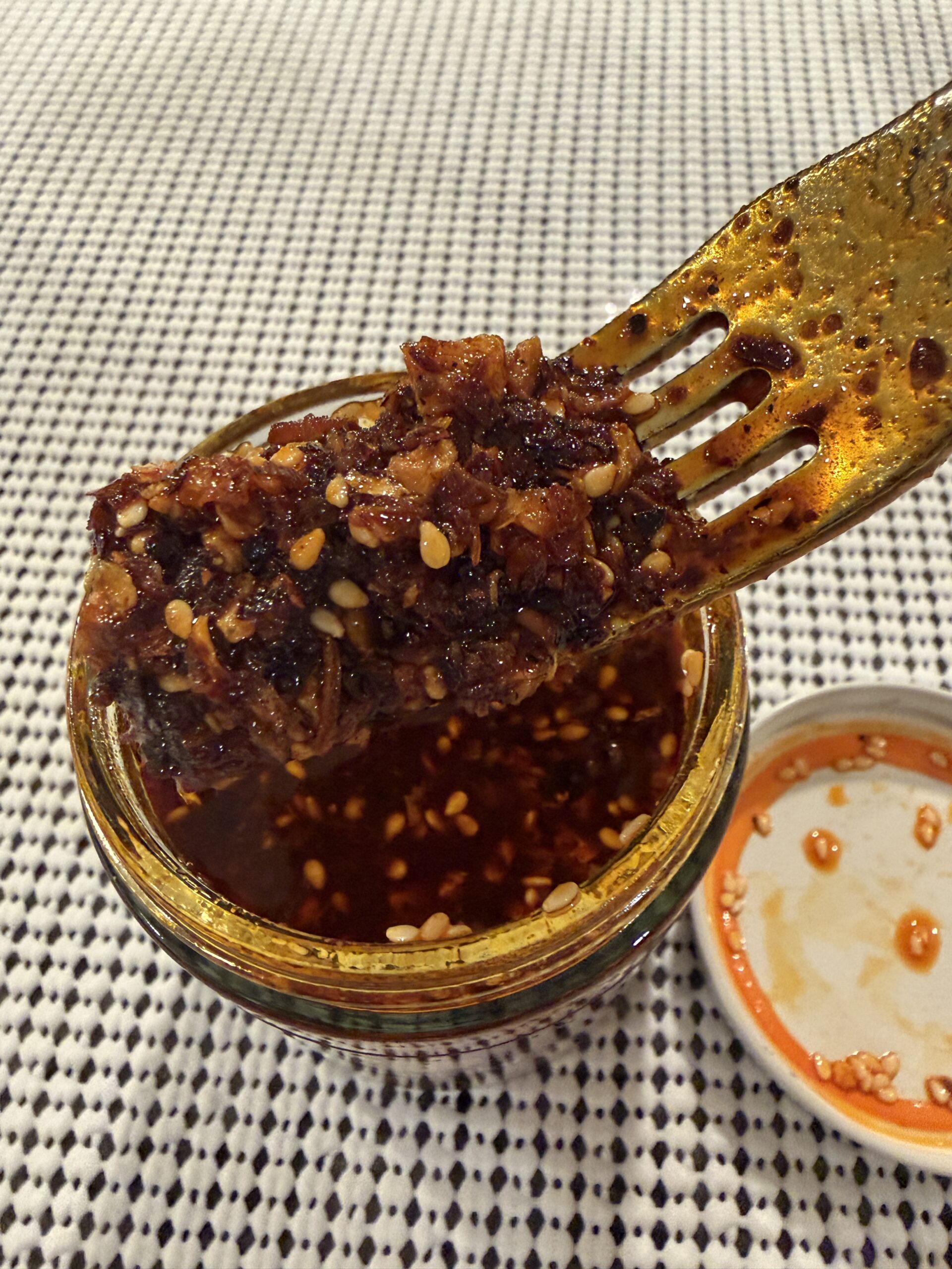 Momofuku Mild Garlic Chili Crunch fork pull showing texture and bit density — Flavor Index Lab