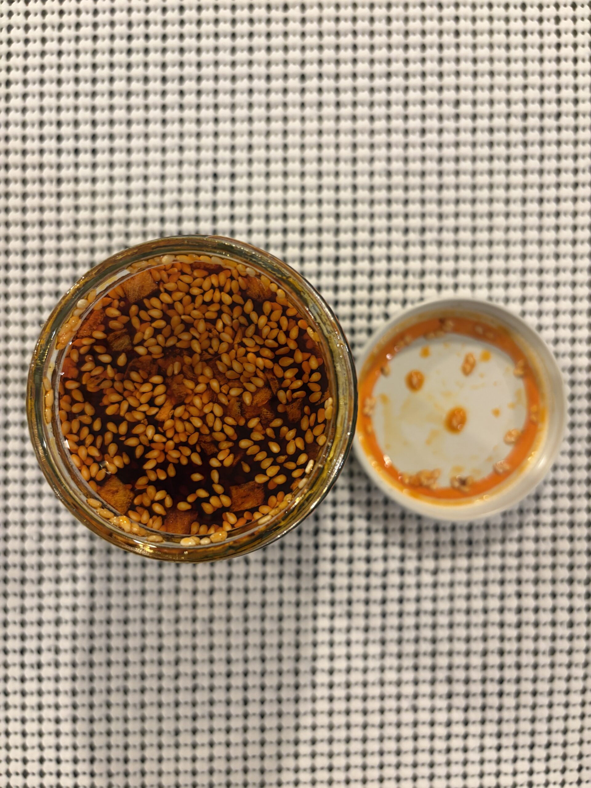 Momofuku Mild Garlic Chili Crunch open jar showing sesame seeds and bits — Flavor Index Lab
