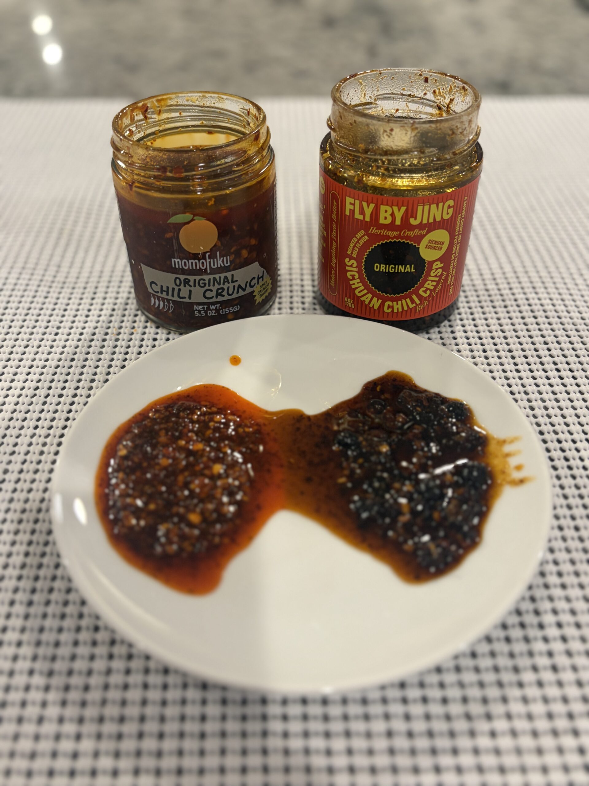 Momofuku and Fly By Jing chili crisp open jars showing color difference — Flavor Index Lab