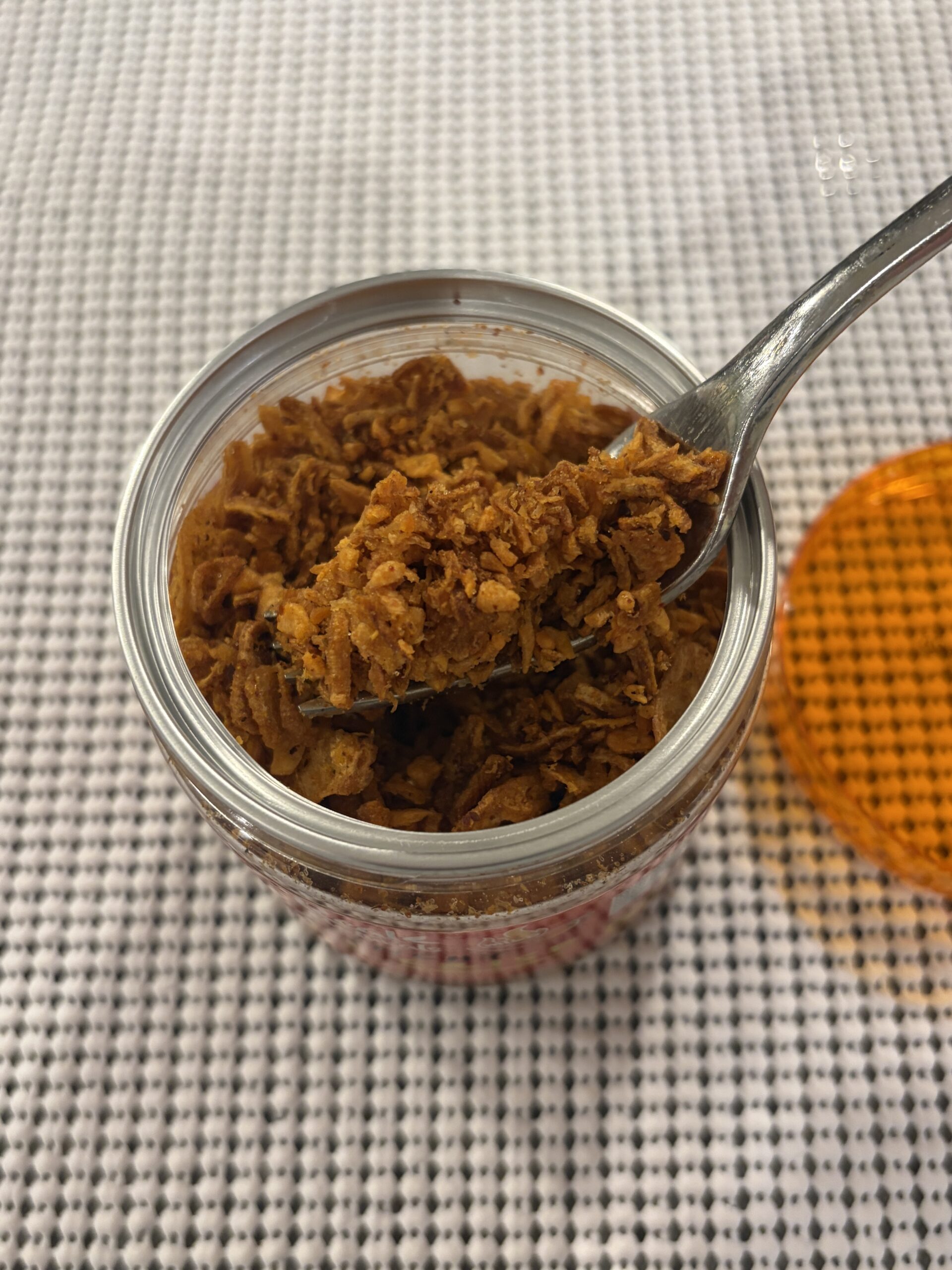 Real Naturals chili crisp fork pull showing crunchy bits — Flavor Index Lab