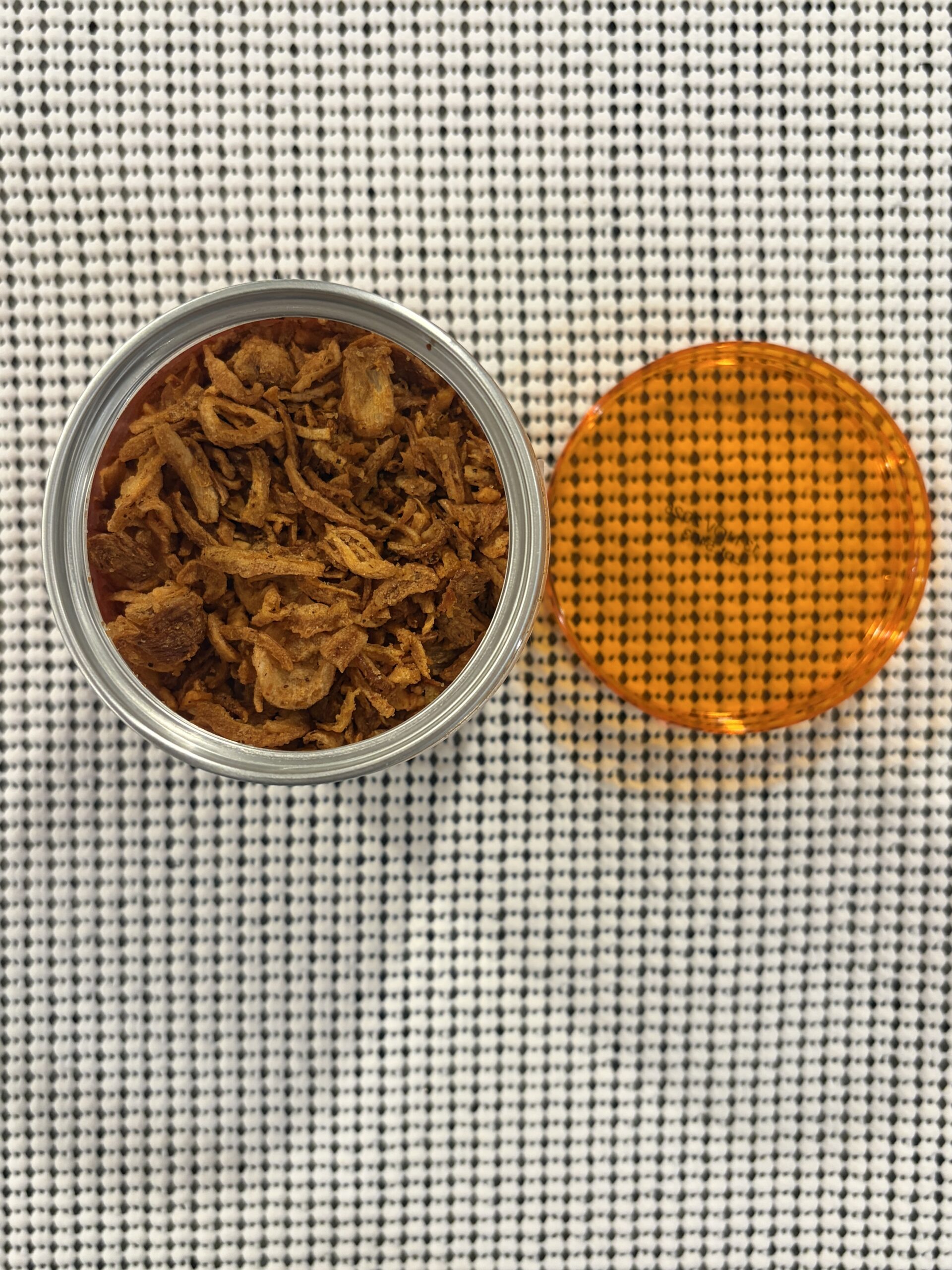 Real Naturals chili crisp open can showing dry crispy bits — Flavor Index Lab