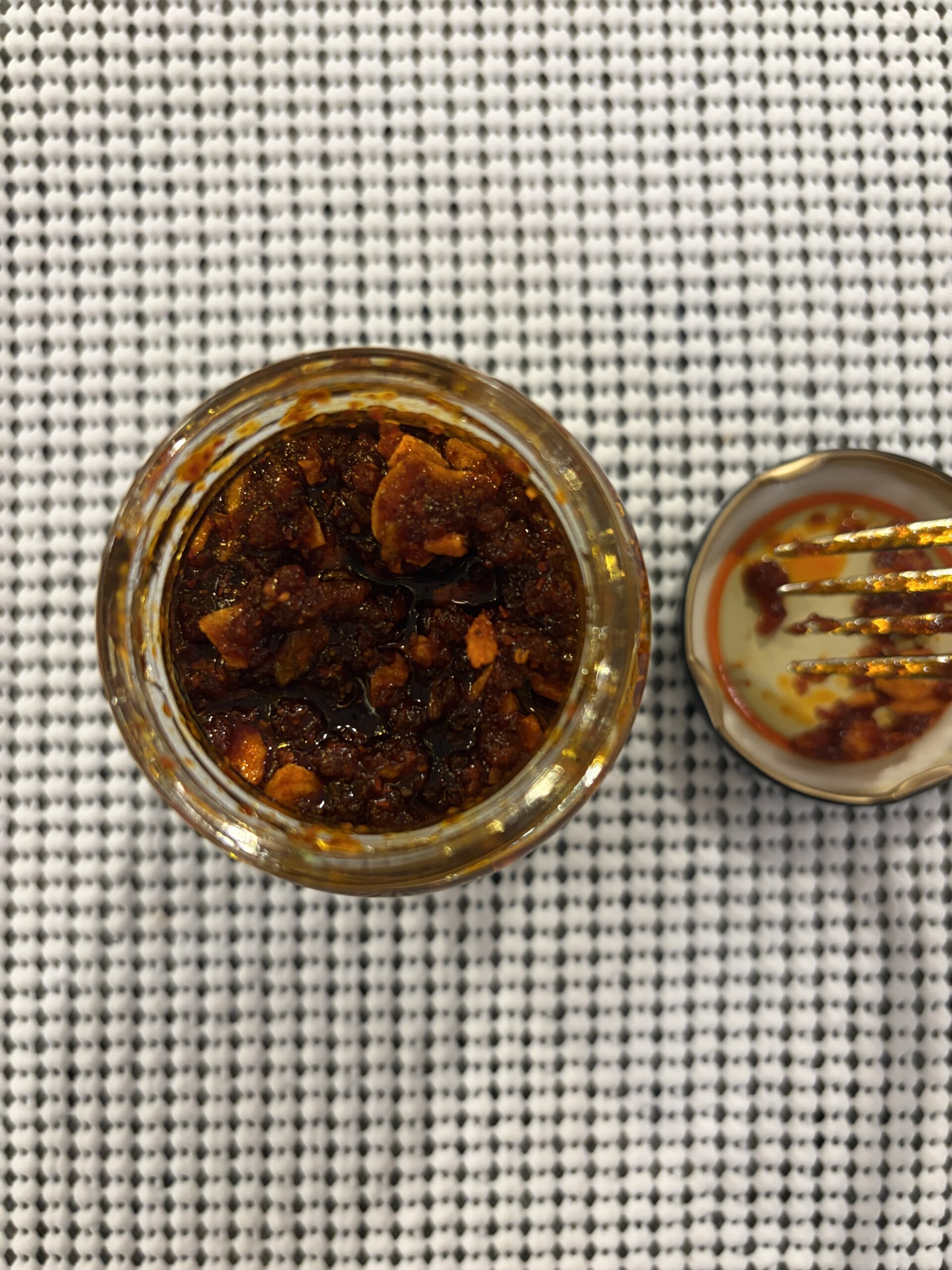 S&B chili crisp review after stirring showing wet sand texture — Flavor Index Lab