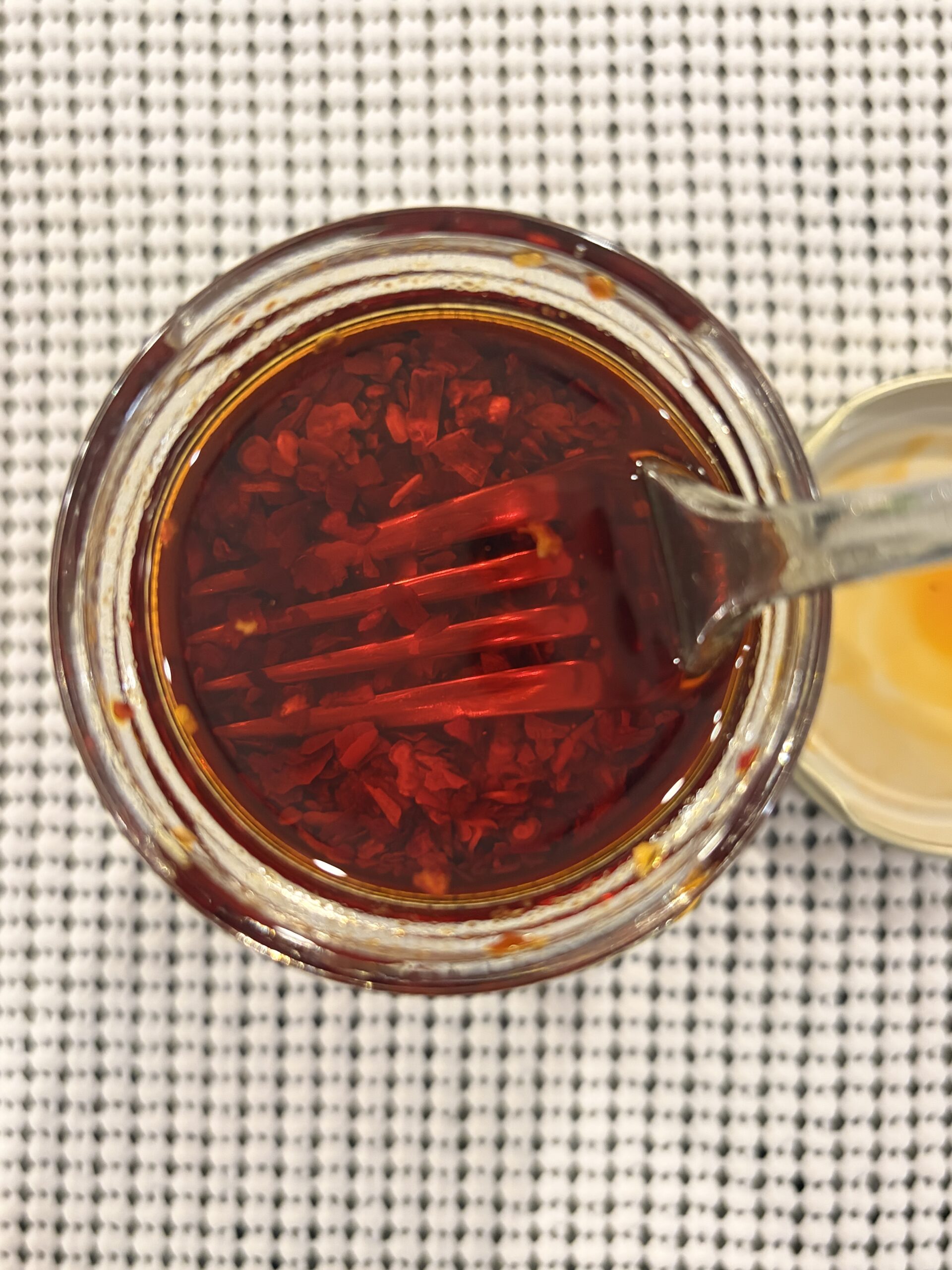 Fork resting on Trader Joe’s Chili Onion Crunch solids before stirring — Flavor Index Lab