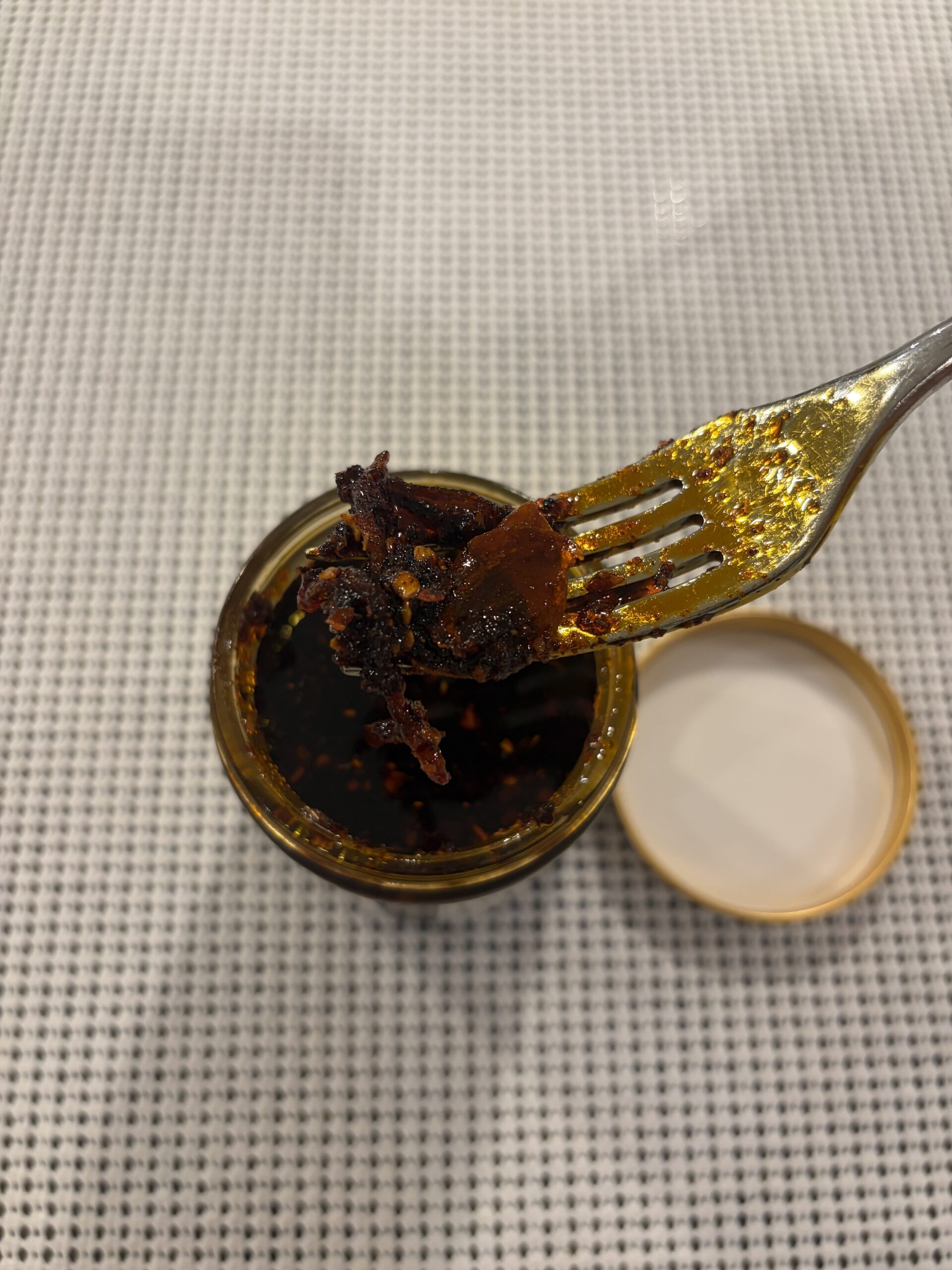 White Elephant Prik Nam Mun chili crisp fork pull close-up — Flavor Index Lab