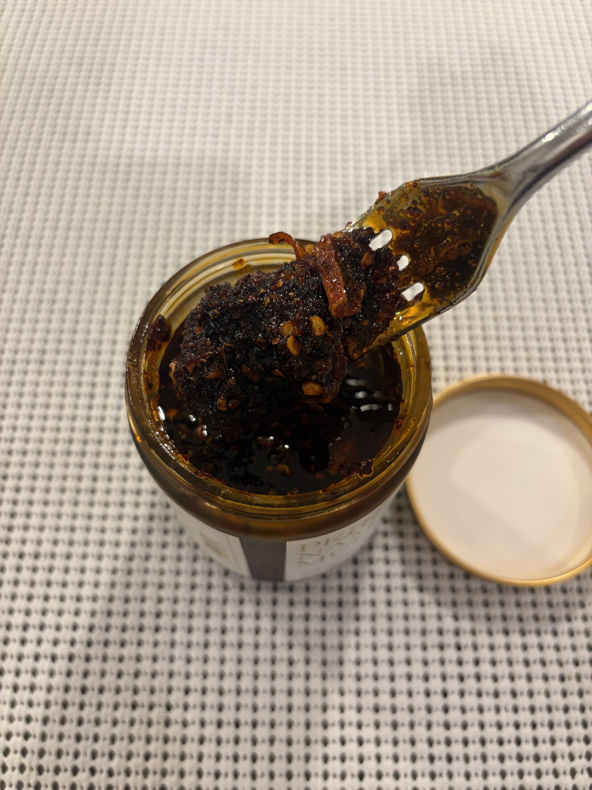 White Elephant Prik Nam Mun chili crisp fork pull with chunky bits — Flavor Index Lab