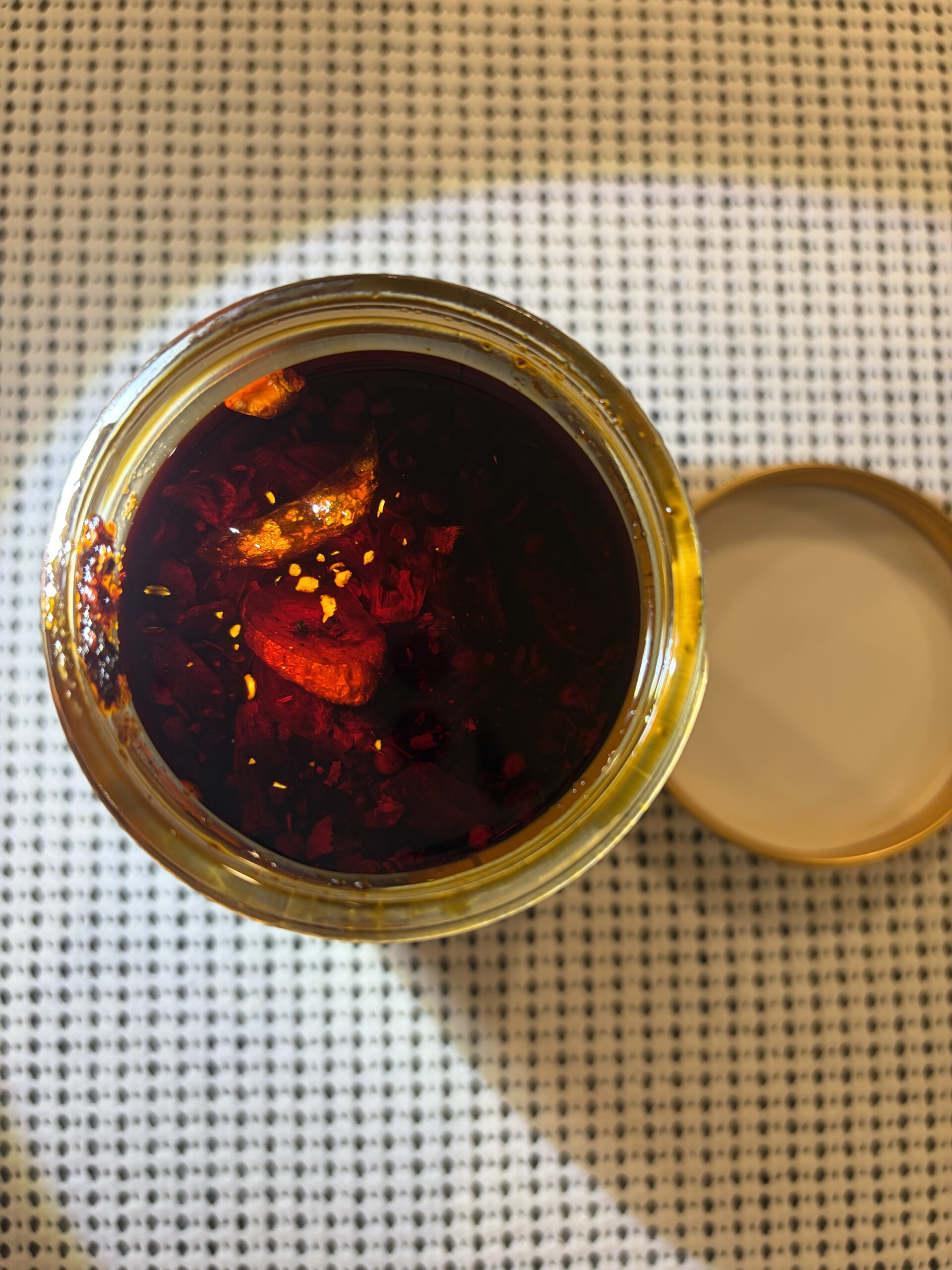 White Elephant Prik Nam Mun open jar with flashlight showing deep settlement — Flavor Index Lab