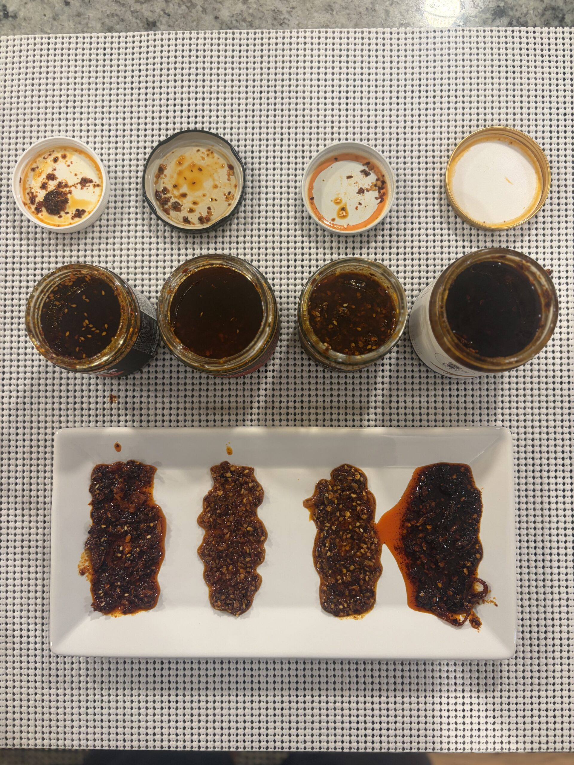 Four truffle chili crisps plated for side-by-side comparison — Flavor Index Lab