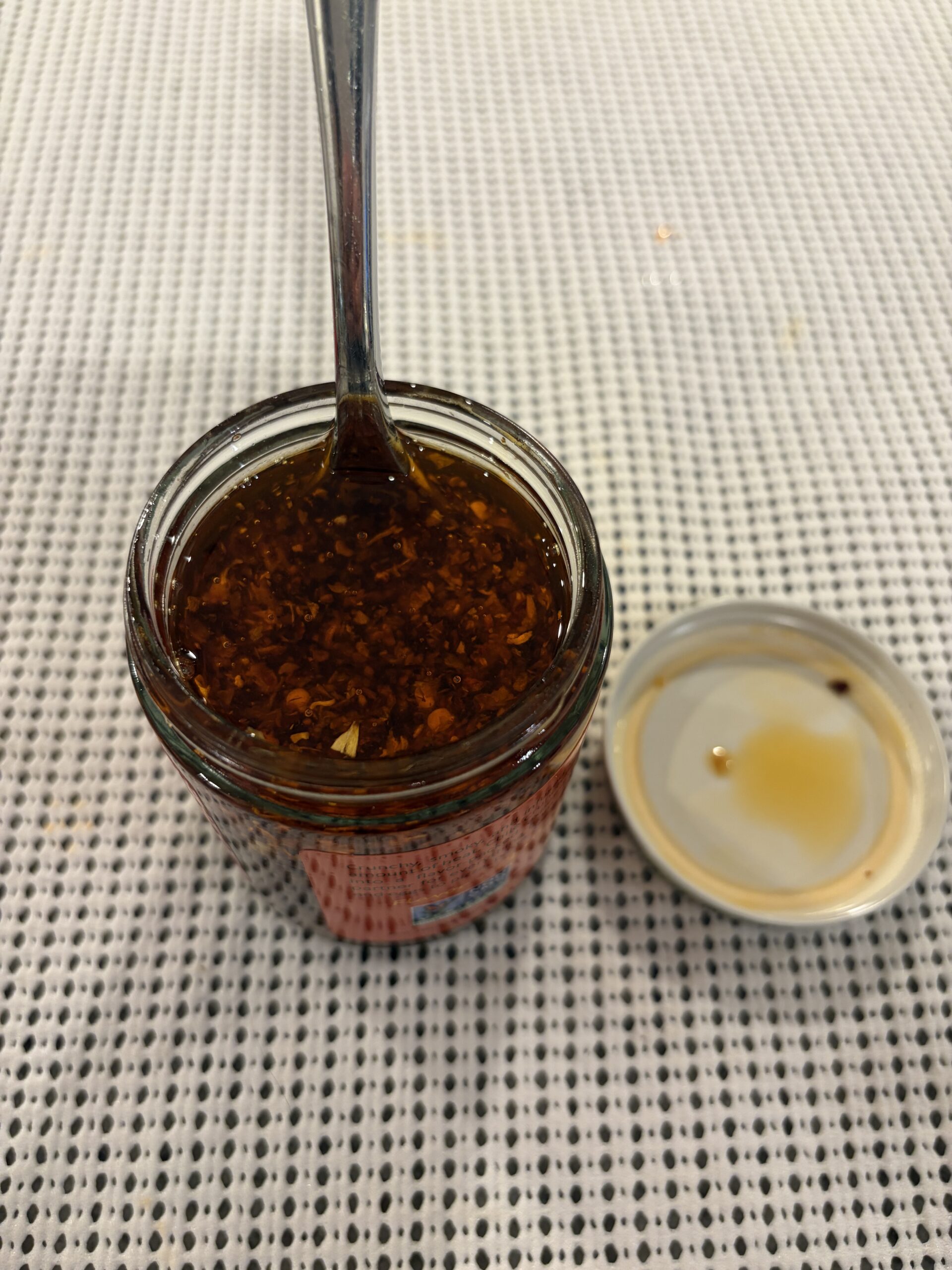 Fork resting in Chile Crunch chili crisp solids — Flavor Index Lab
