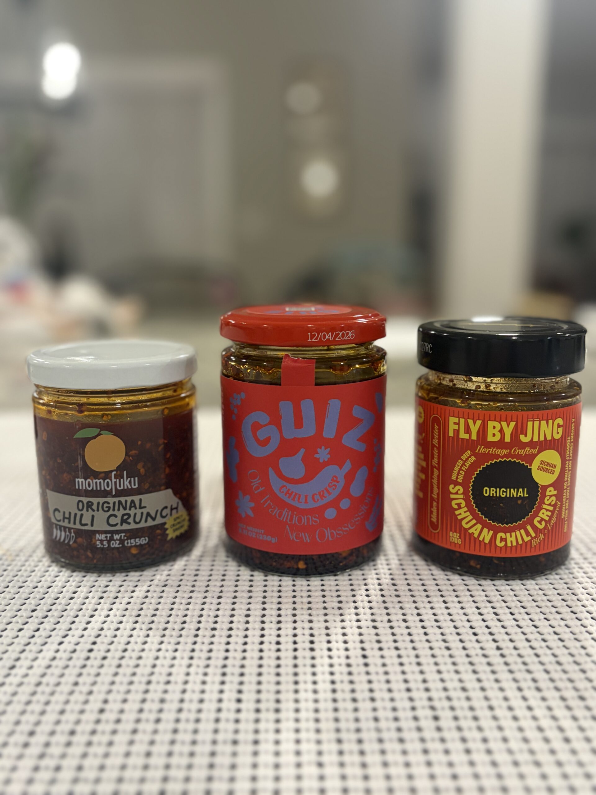 Three chili crisp jars compared side by side — Flavor Index Lab