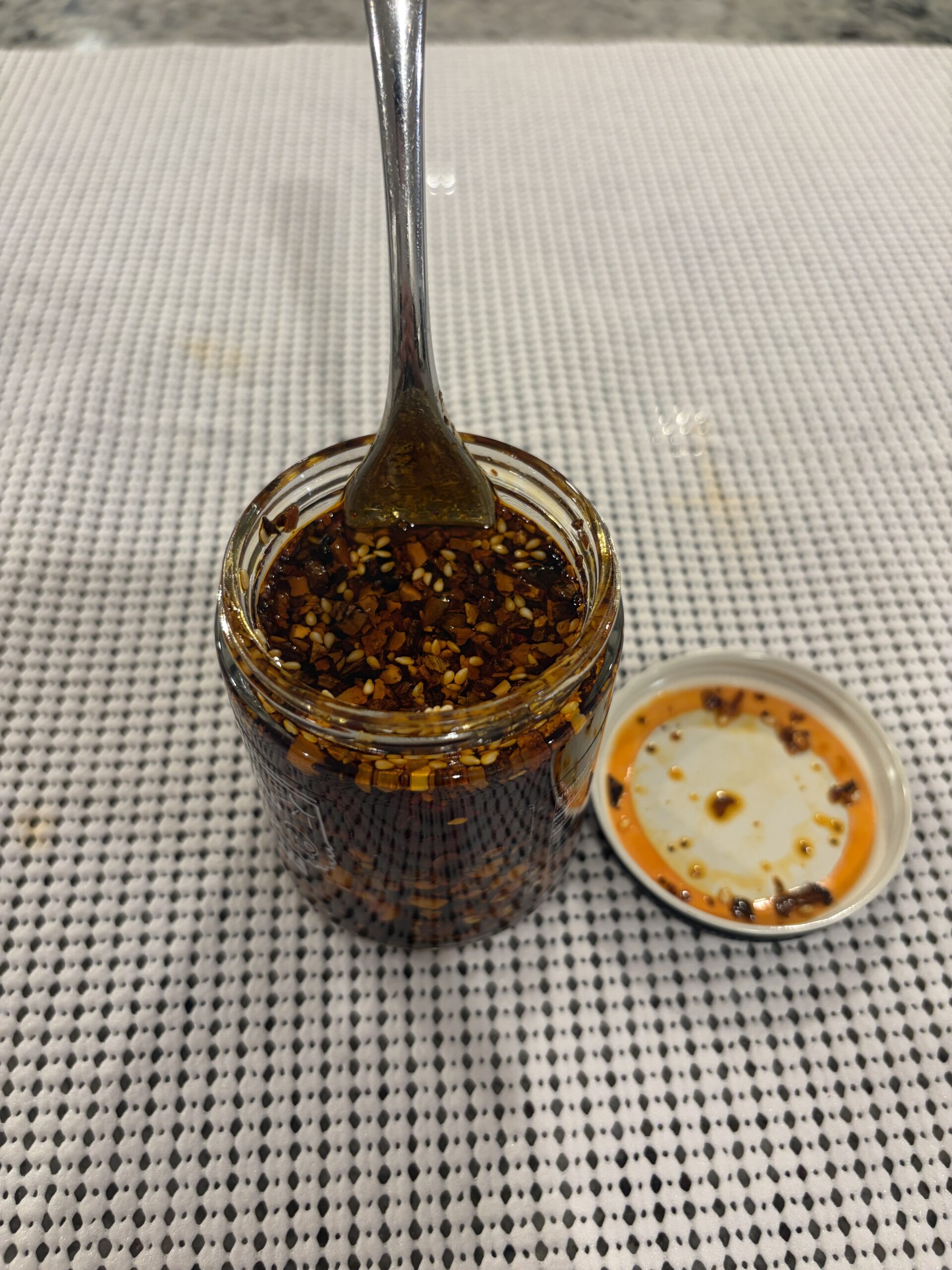 Fork resting on CHiNGONAs salsa macha solids — Flavor Index Lab
