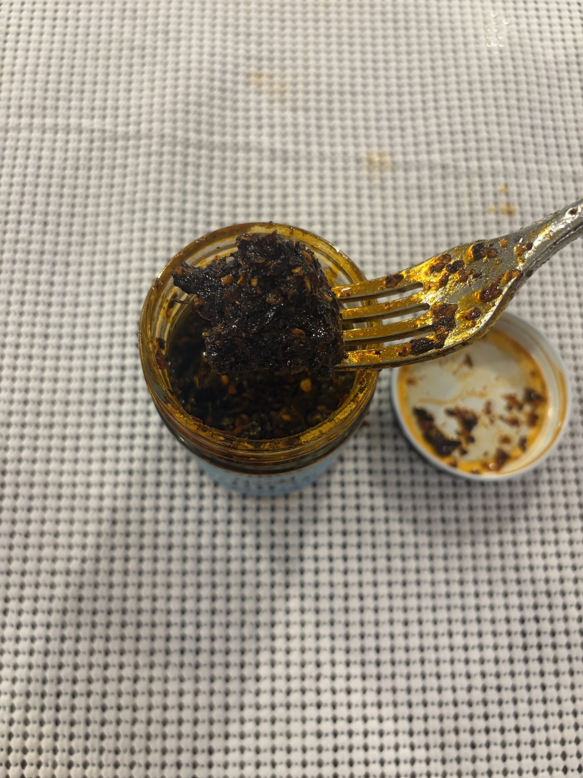 Don Chilio Árbol salsa macha fork pull showing texture . Flavor Index Lab