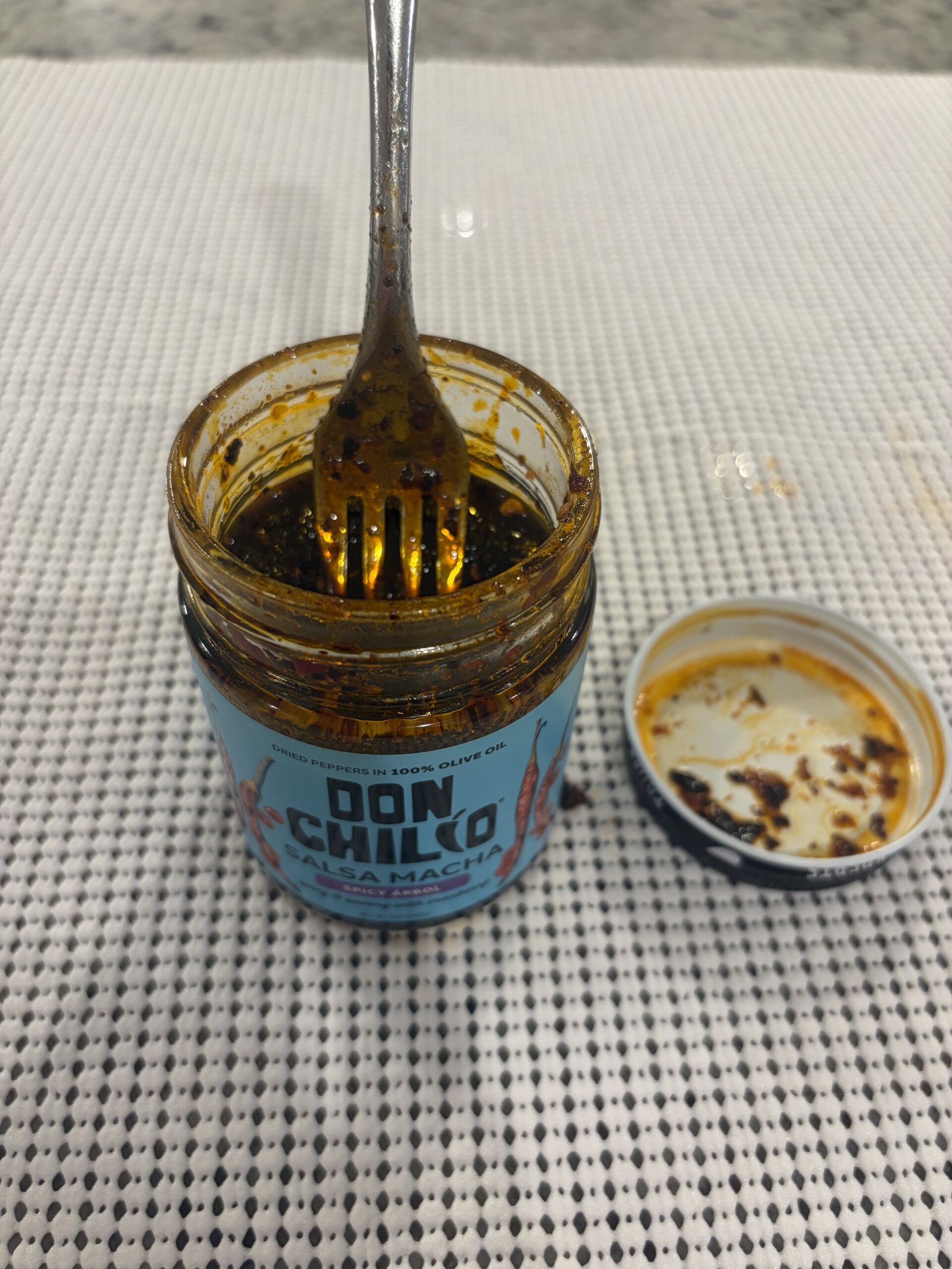 Fork resting on Don Chilio Árbol salsa macha solids . Flavor Index Lab