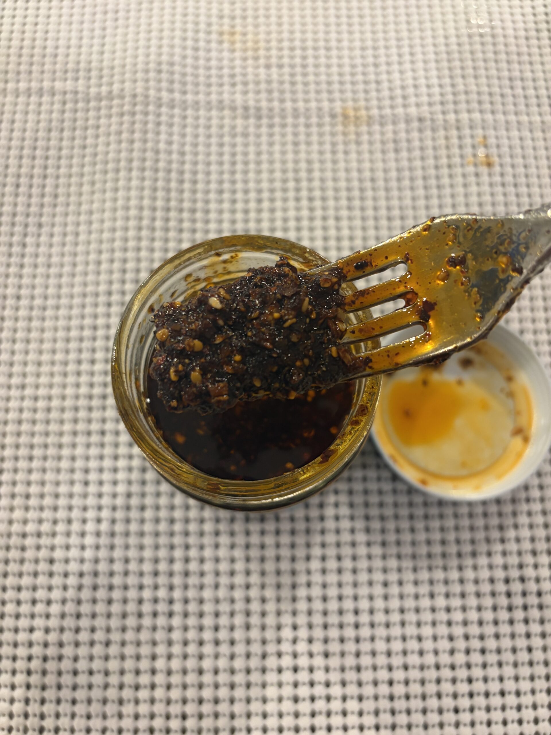 Don Chilio Chipotle Salsa Macha fork pull showing oil and chili texture . Flavor Index Lab