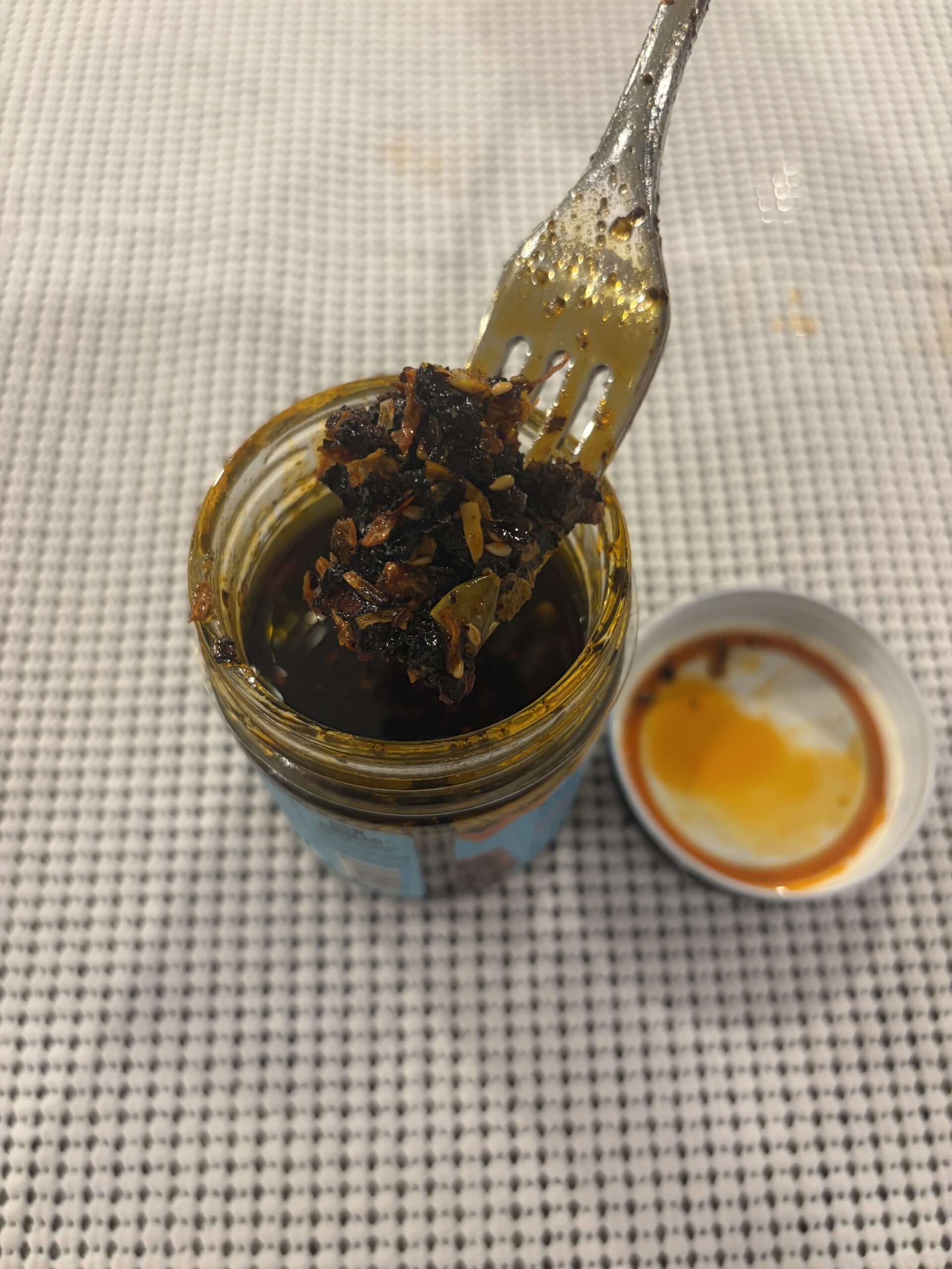 Don Chilio Morita salsa macha fork pull showing chunks and oil . Flavor Index Lab