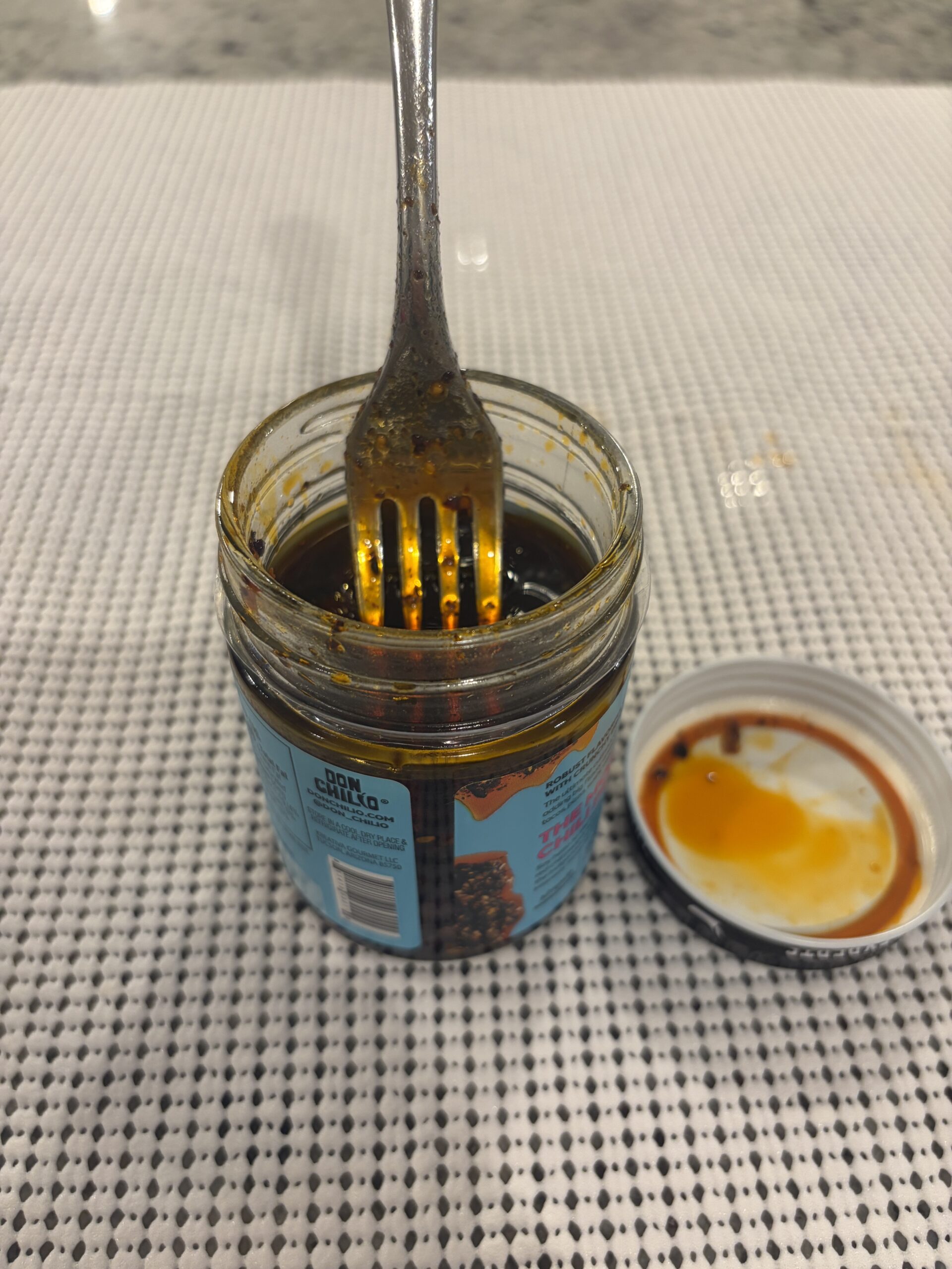 Fork resting on Don Chilio Morita salsa macha solids . Flavor Index Lab