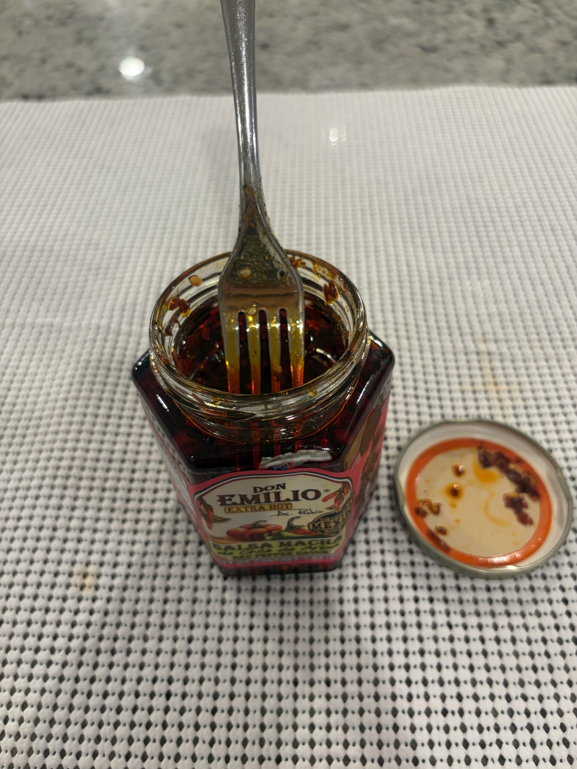 Fork resting on Don Emilio salsa macha solids before stirring — Flavor Index Lab