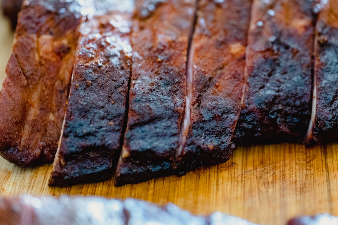 Sliced BBQ brisket on cutting board — Flavor Index Lab