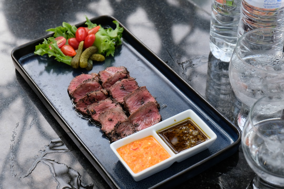 Steak on plate with chili crisp condiment — Flavor Index Lab