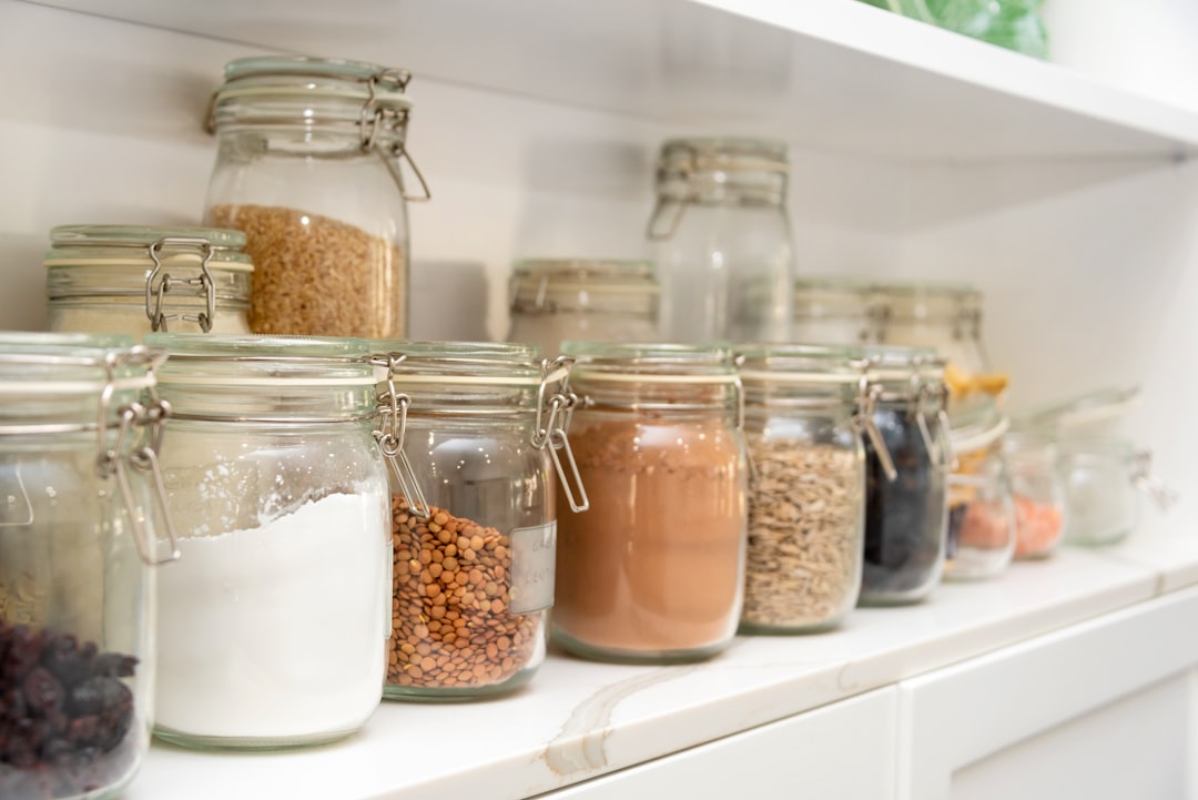 Organized pantry shelf with glass jars of dry goods and staples — Flavor Index Lab