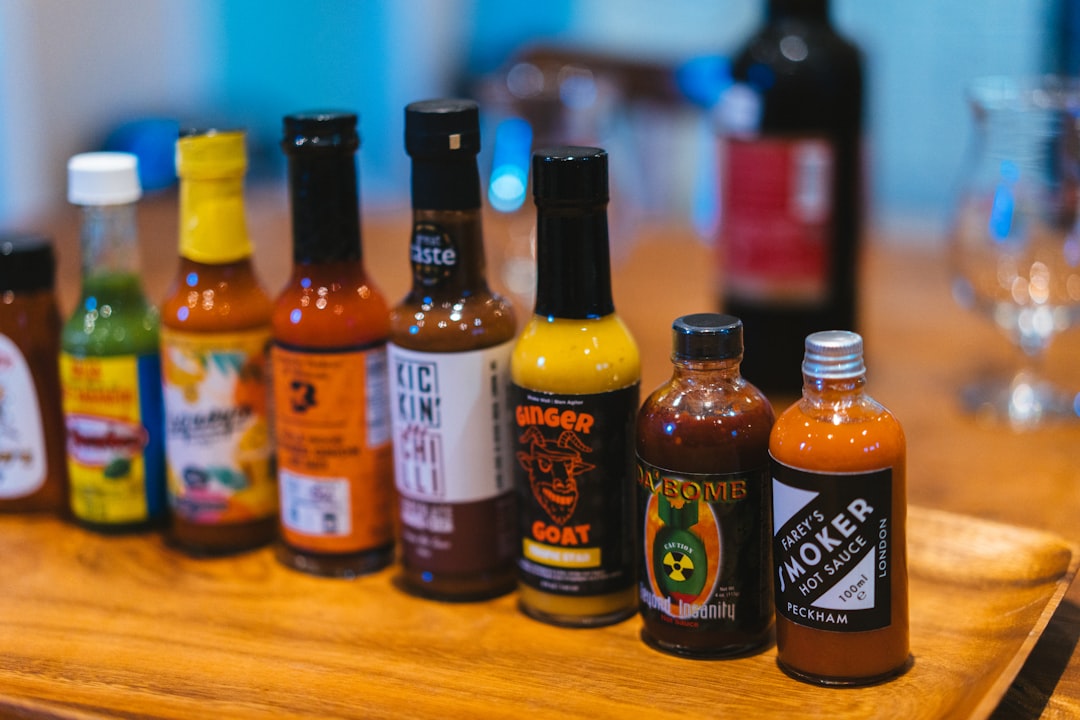 Variety of hot sauce and condiment bottles — Flavor Index Lab