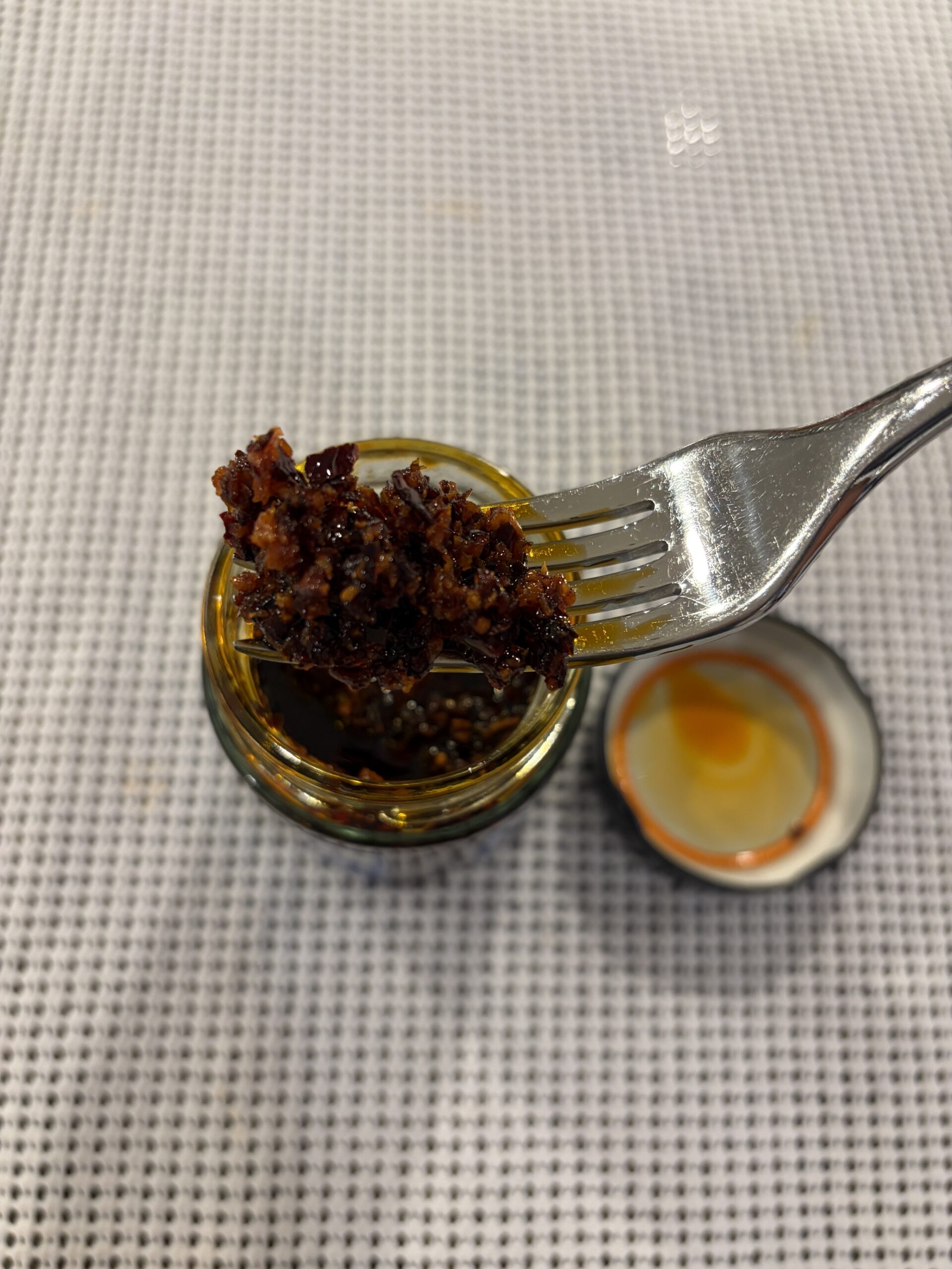 Fly By Jing Mild chili crisp fork pull showing chunky bits — Flavor Index Lab