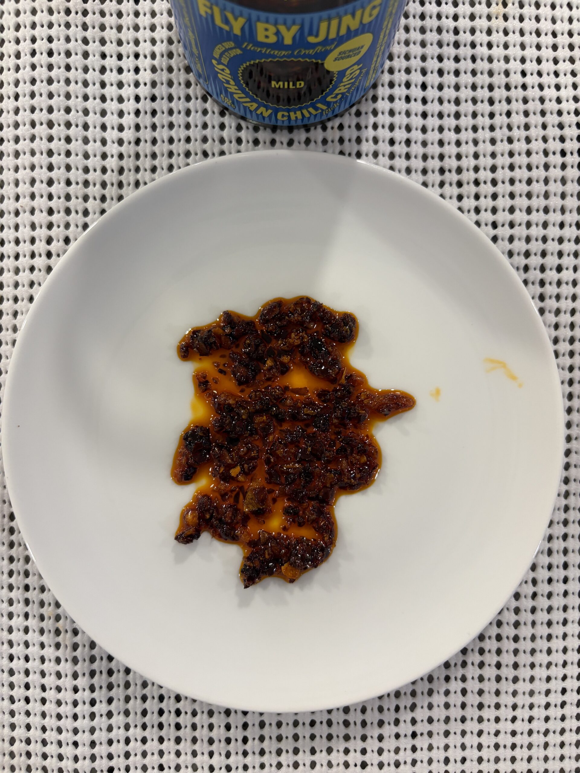 Fly By Jing Mild chili crisp plated showing chunks and oil — Flavor Index Lab