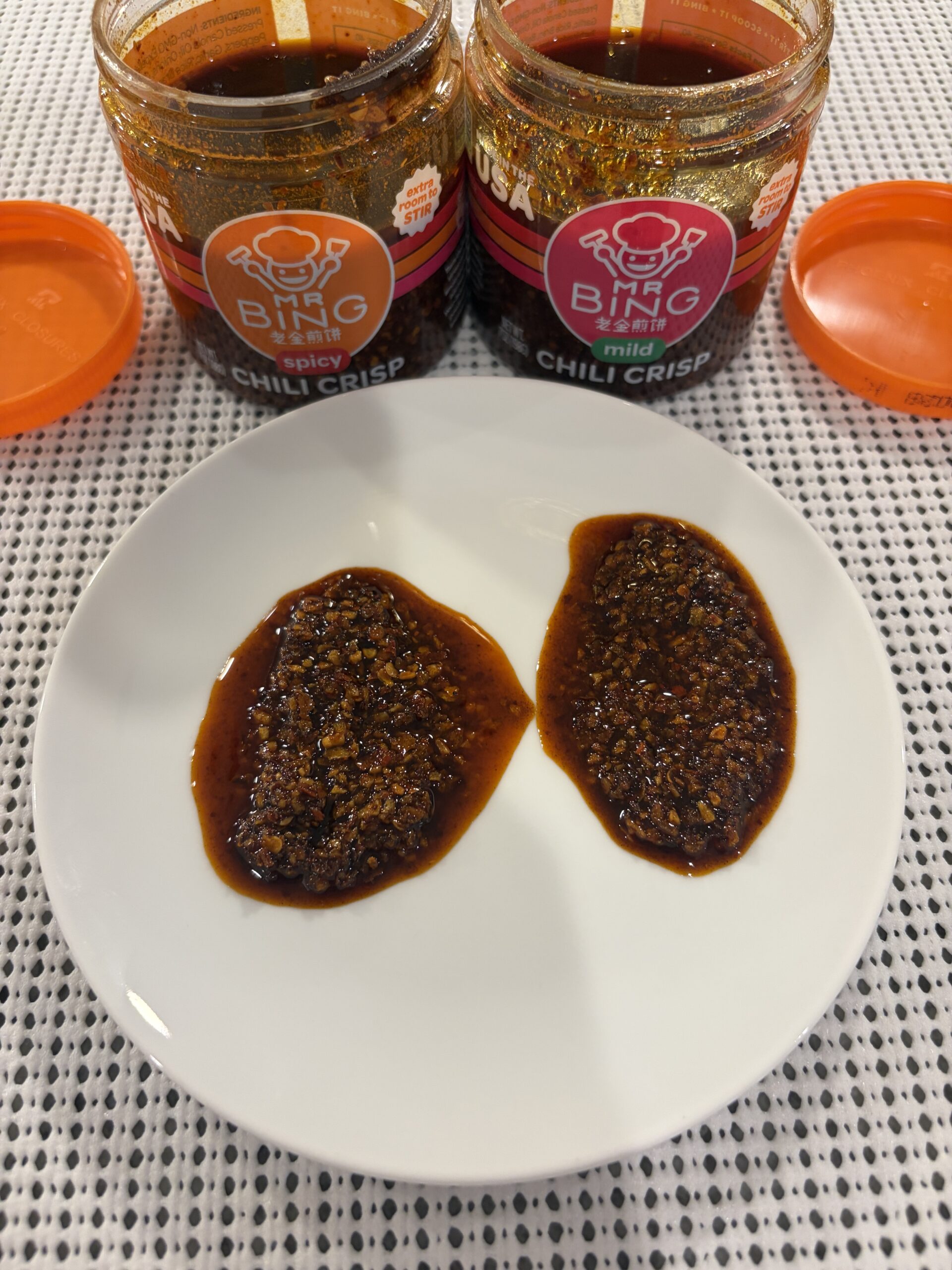 Mr. Bing mild and spicy chili crisp plated with front labels — Flavor Index Lab
