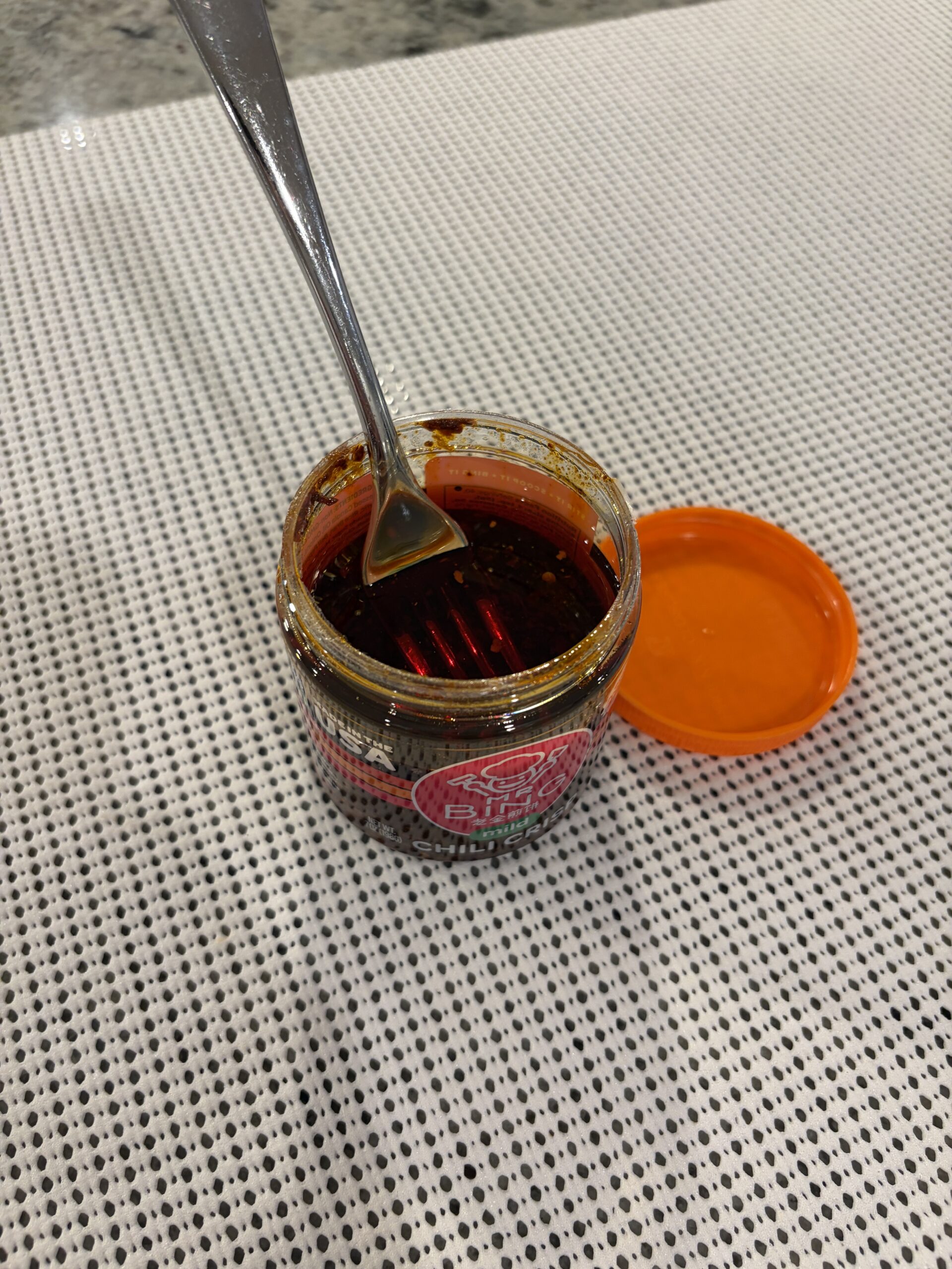 Fork resting on Mr. Bing mild chili crisp solids — Flavor Index Lab