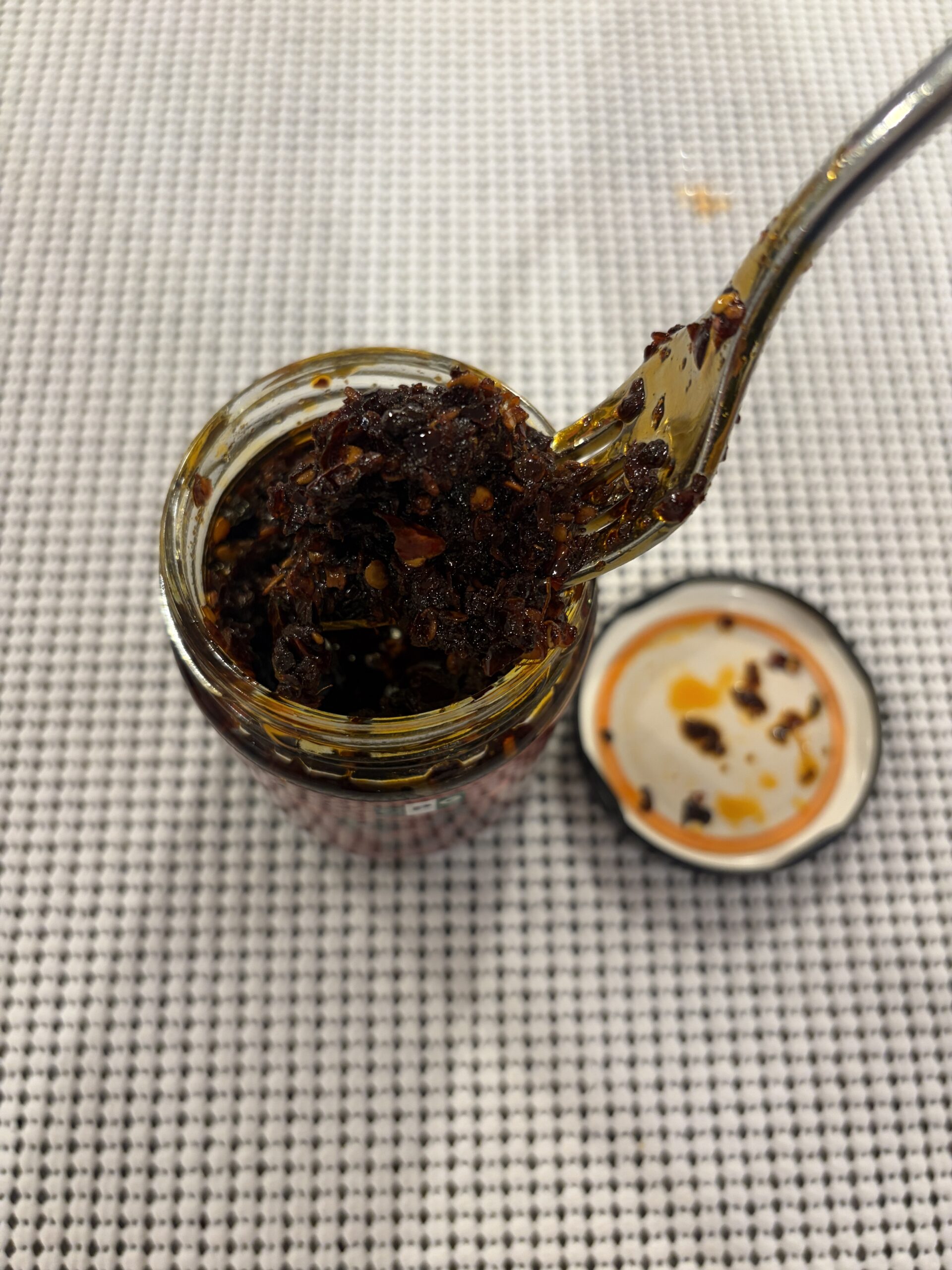 NPG Sichuan chili oil fork pull with chili flakes and peppercorn — Flavor Index Lab