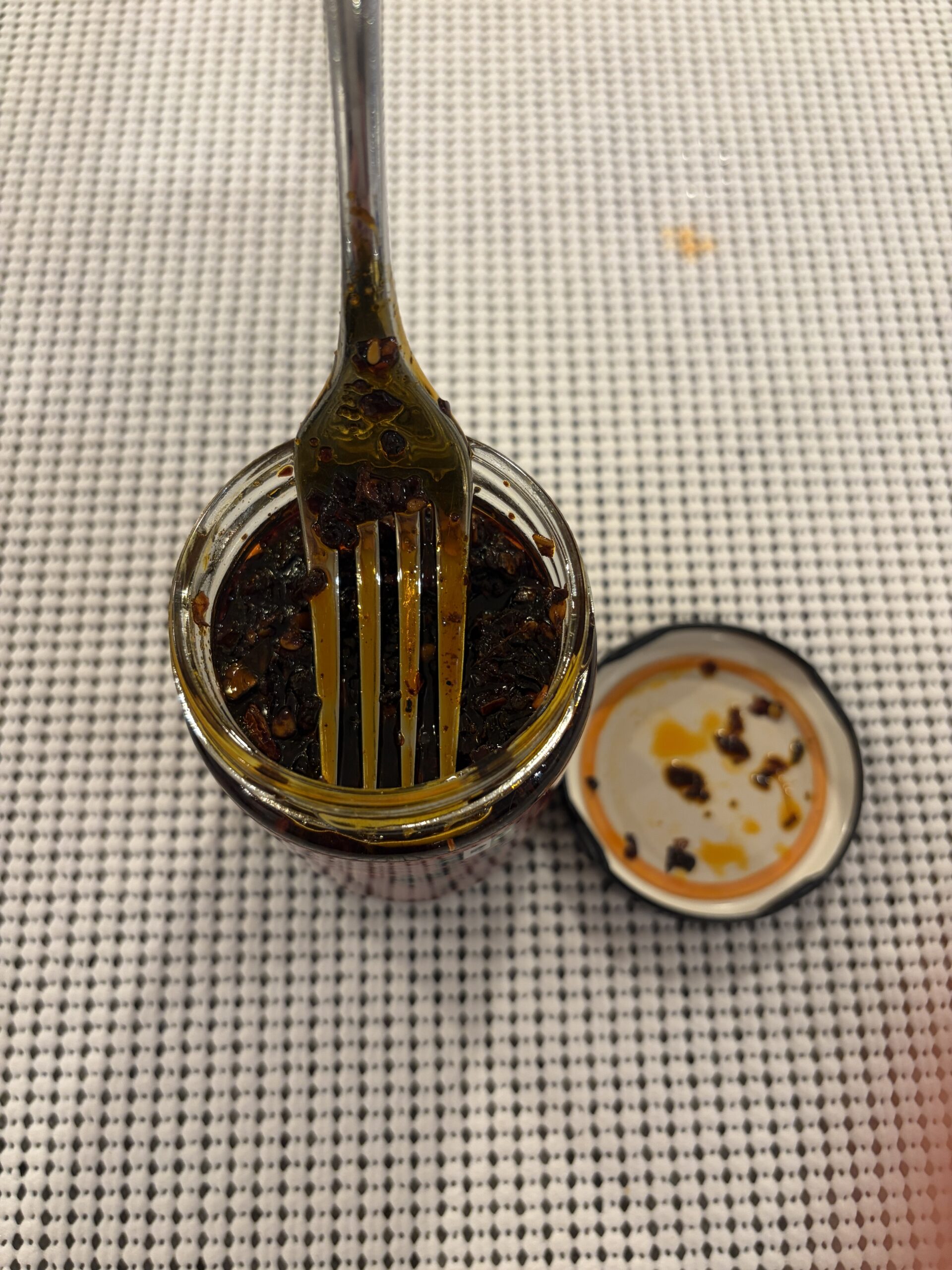 Fork resting on NPG Sichuan chili oil solids — Flavor Index Lab
