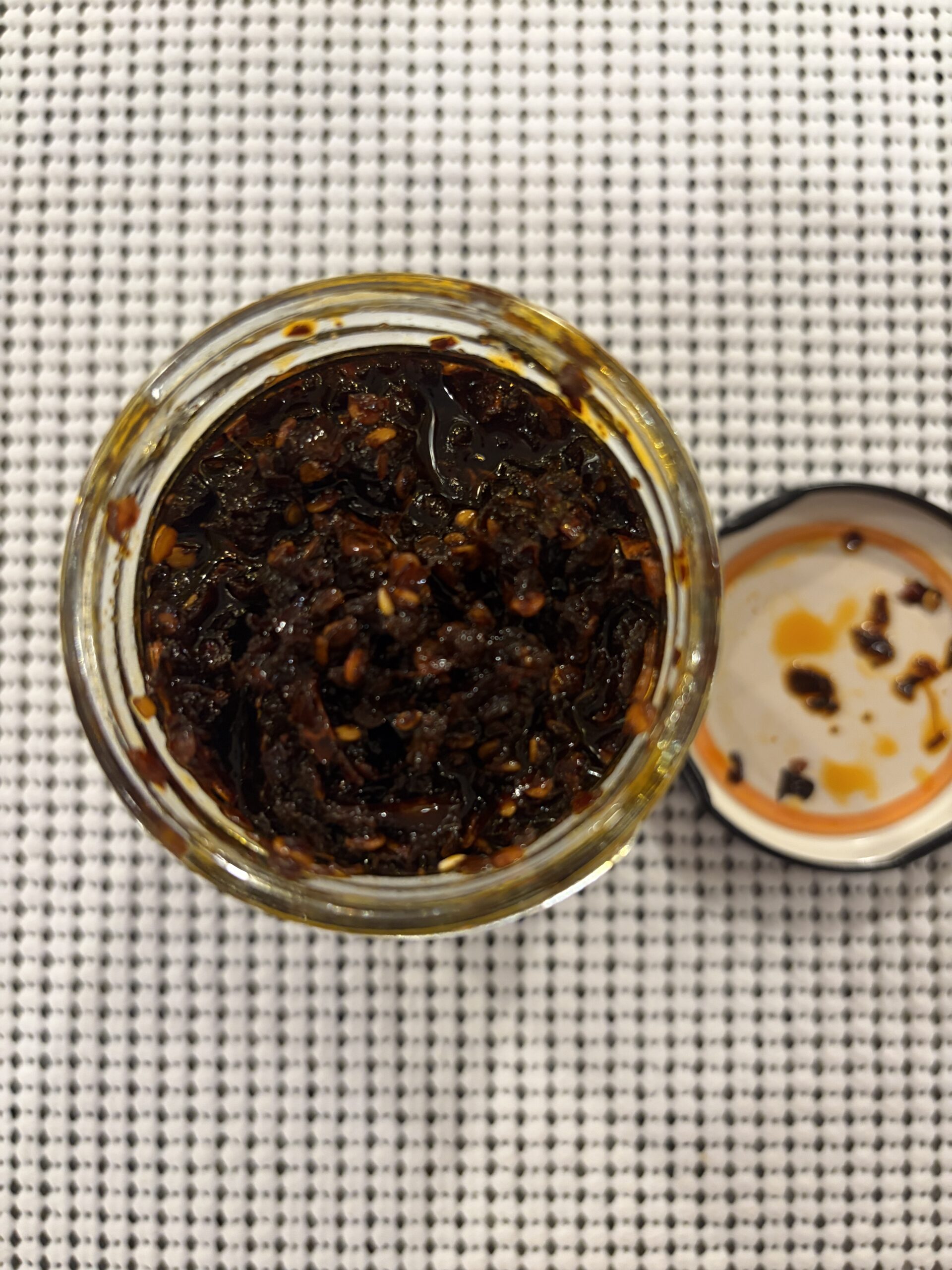 NPG Sichuan chili oil open jar with chili bits above oil line — Flavor Index Lab