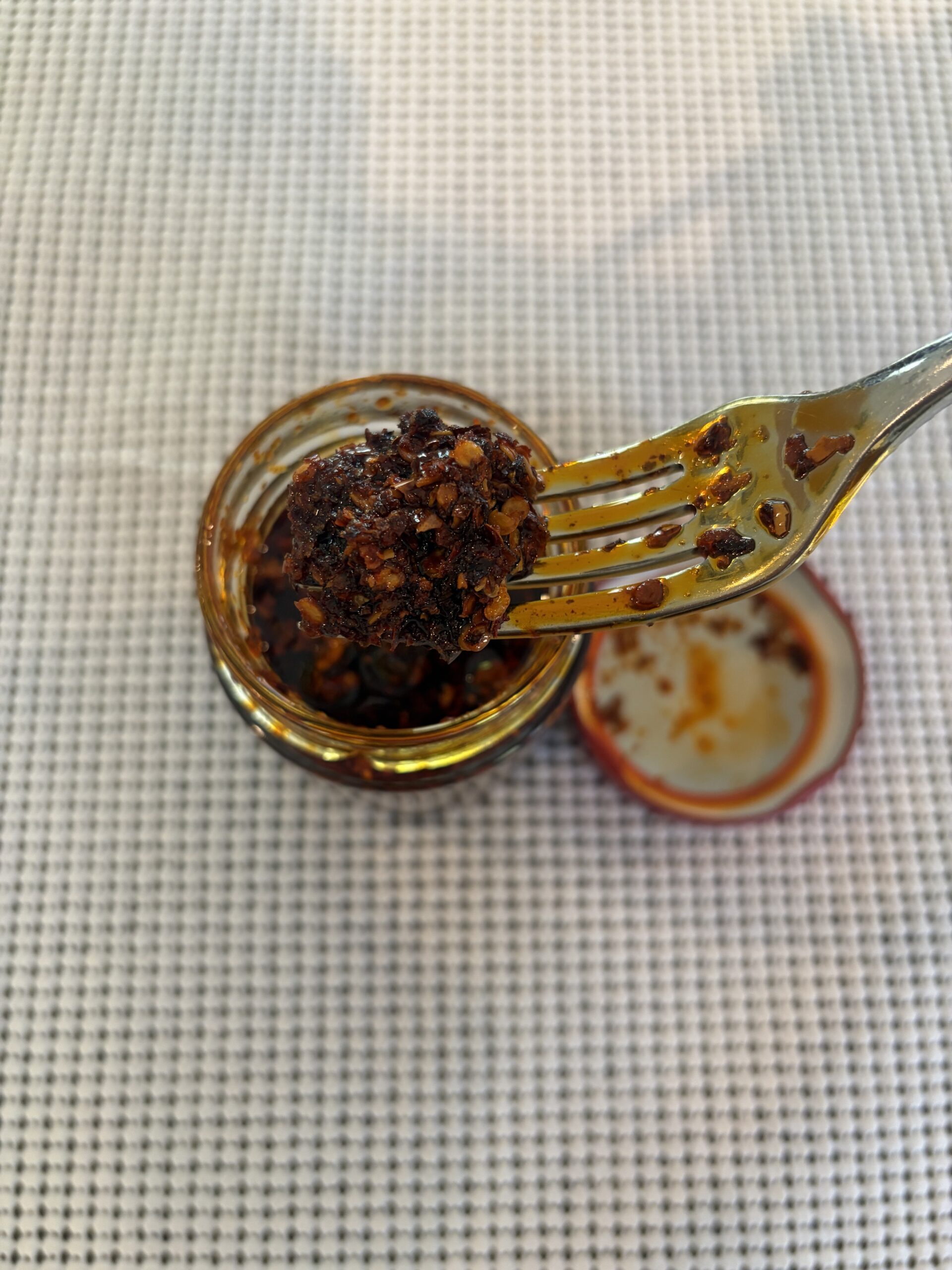 Redbloom Aroma chili crisp fork pull showing oil and bits — Flavor Index Lab